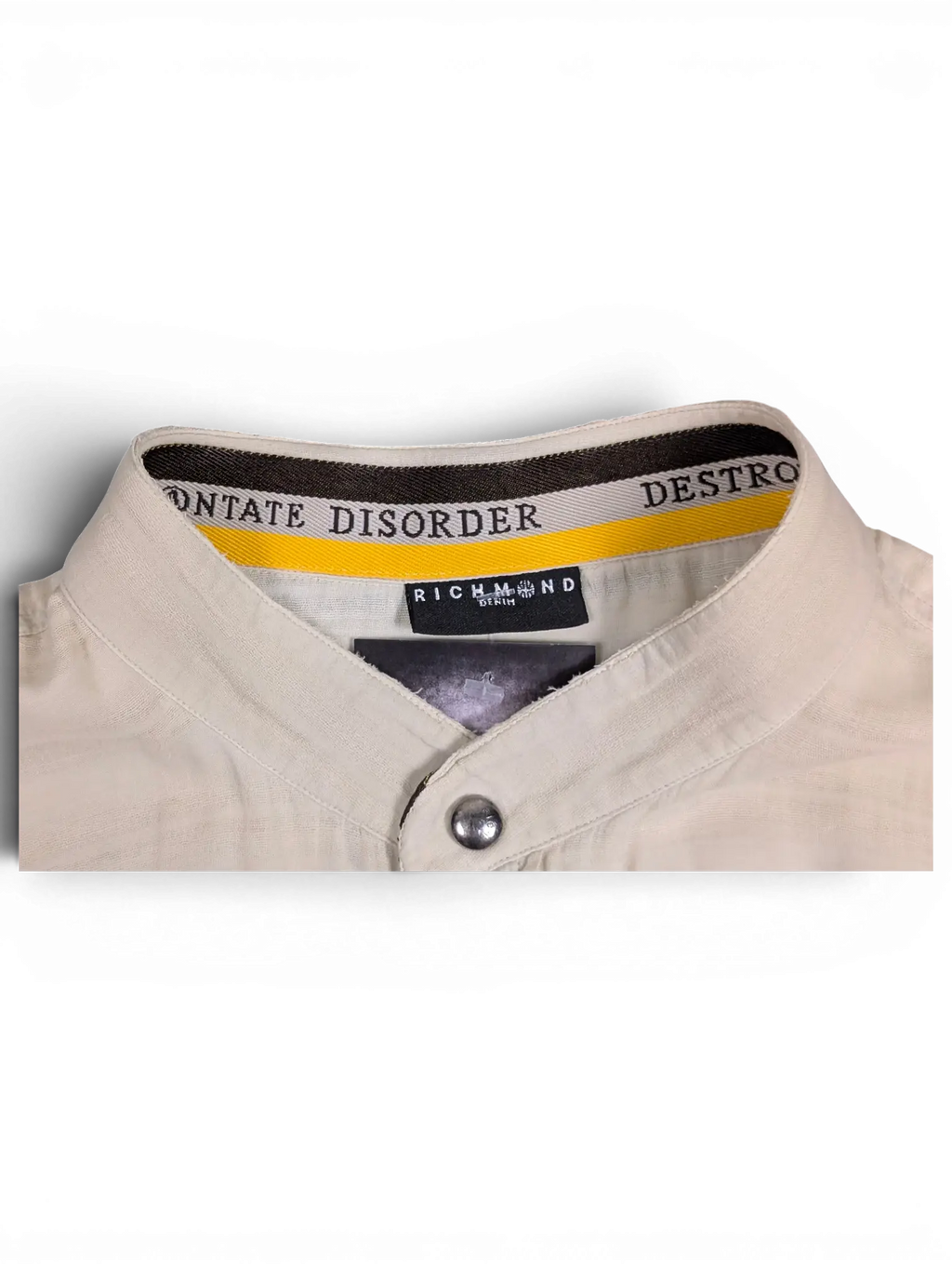 JAKE & IPI beige Disorder Richmond utility shirt featuring a stand collar with branded interior trim and snap buttons