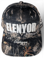 JAKE & IPI Elenyor baseball cap in a woodland camouflage print with white embroidered lettering on the front.