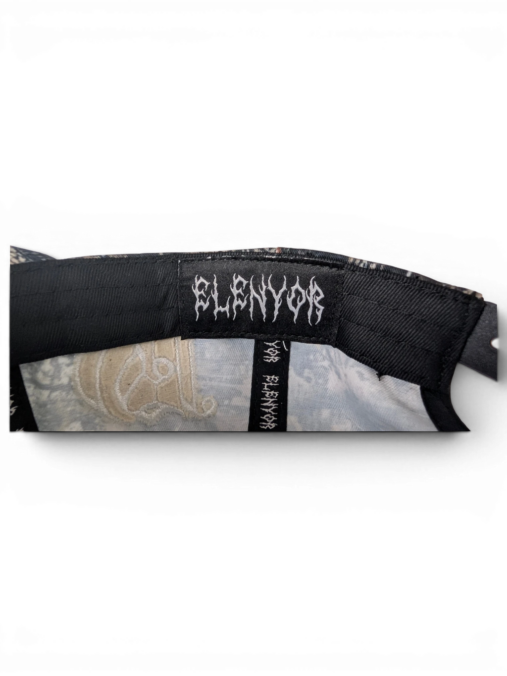 JAKE & IPI IBE Elenyor cap interior detail featuring a black branded label with gothic style white lettering