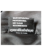 JAKE & IPI Elenyor jacket interior care label with washing instructions and Designed with Love in Finland text