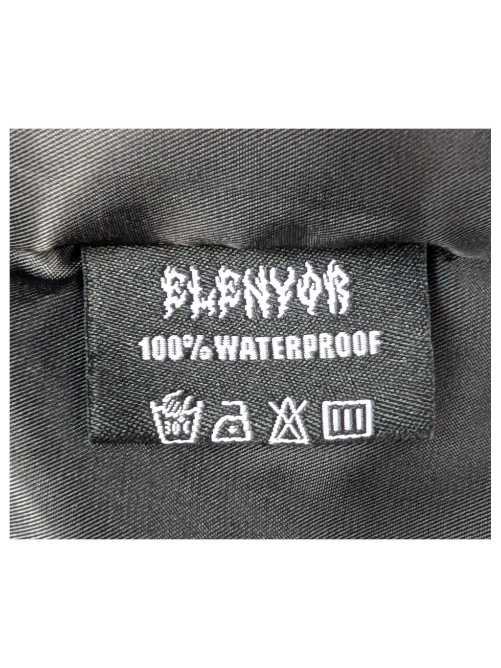 JAKE & IPI Elenyor jacket black interior label with 100% waterproof text and care instructions