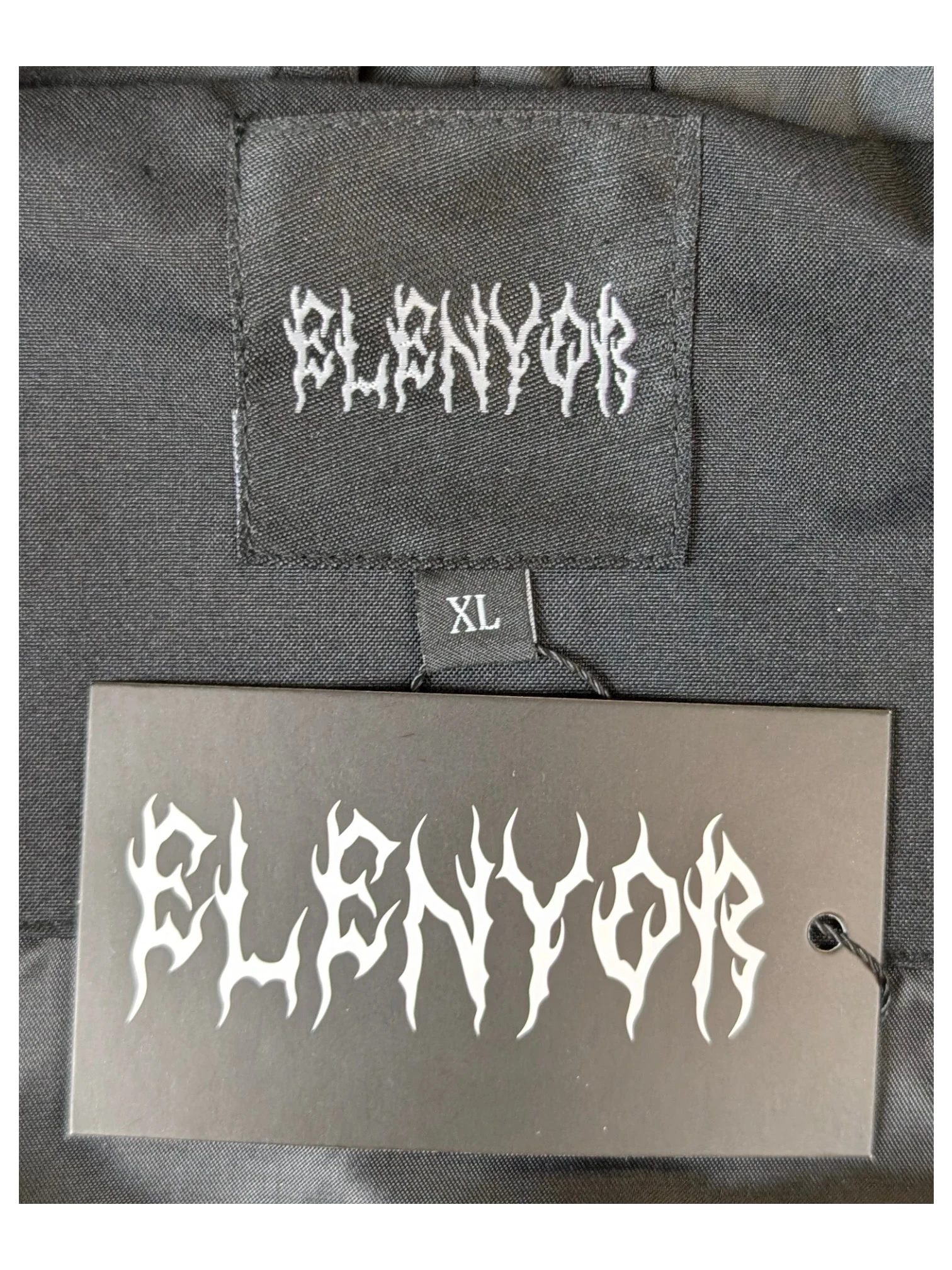 JAKE & IPI Elenyor jacket featuring a black fabric label and matching hang tag with gothic style white logo text