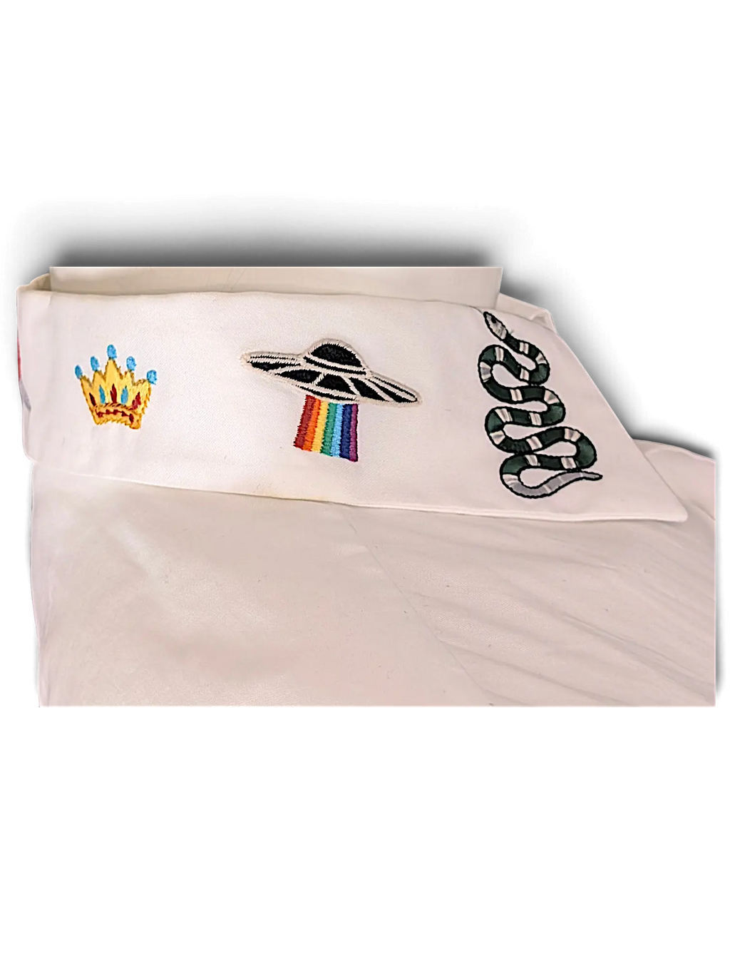 JAKE & IPI white shirt collar featuring embroidered crown, rainbow UFO, and snake motifs
