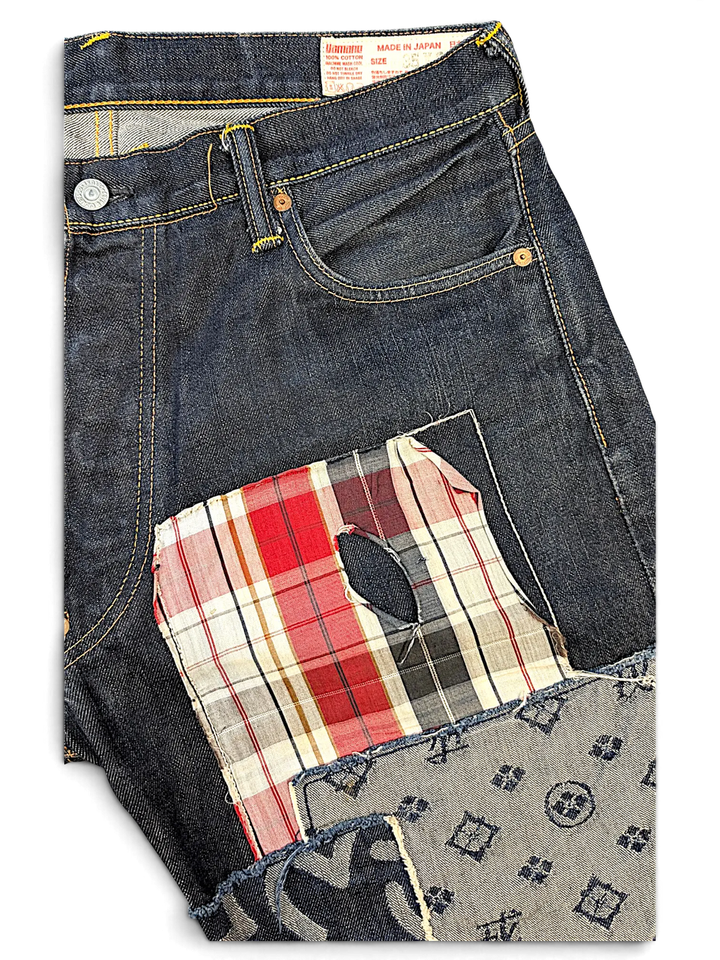 JAKE & IPI Evisu one of one dark wash denim jeans featuring a distressed red plaid patch and patterned fabric detail.