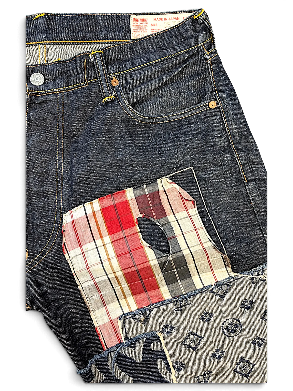 JAKE & IPI Evisu one of one dark wash denim jeans featuring a distressed red plaid patch and patterned fabric detail.