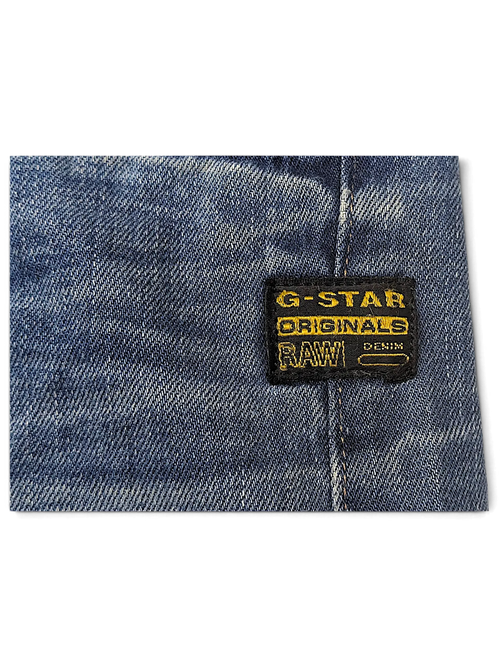 JAKE & IPI G-Star Jeans featuring a blue denim fabric with a black and yellow brand logo patch detail.