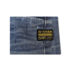 JAKE & IPI G-Star -farkut: sininen denim ja musta-keltainen logomerkki.