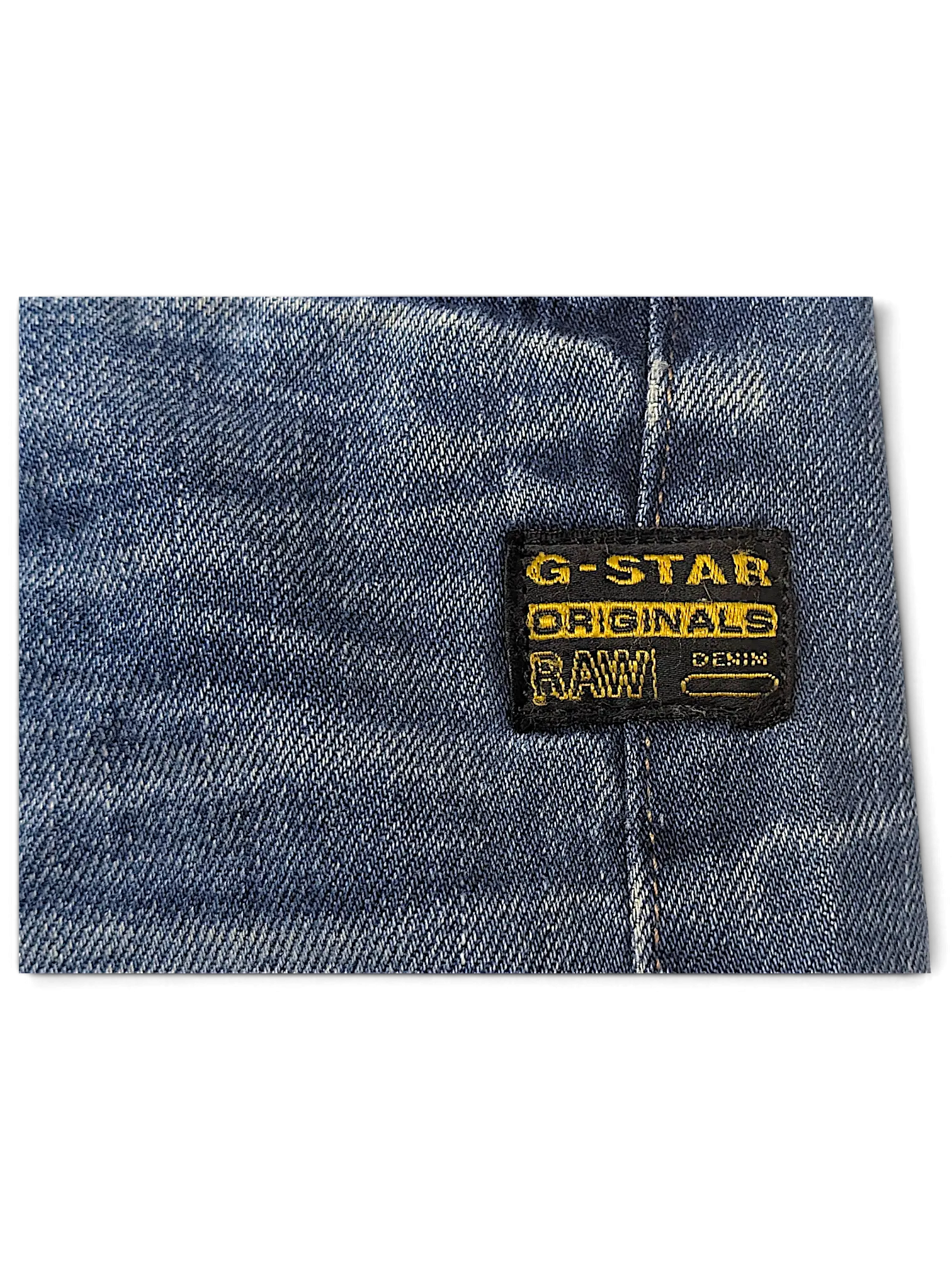 JAKE & IPI G-Star Jeans featuring a blue denim fabric with a black and yellow brand logo patch detail.