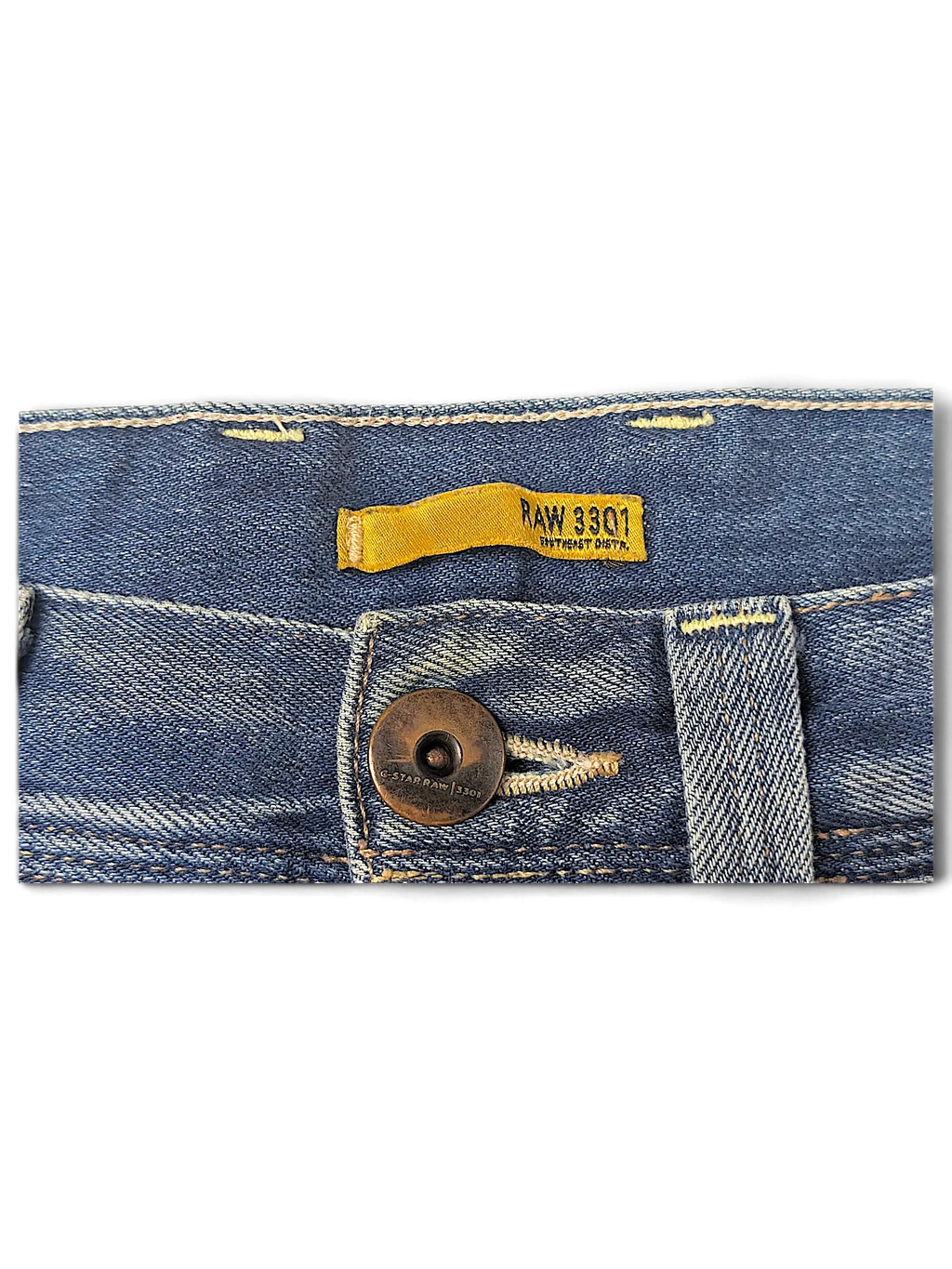 JAKE & IPI G-Star RAW 3301 blue denim jeans featuring a classic button fly and yellow interior brand label