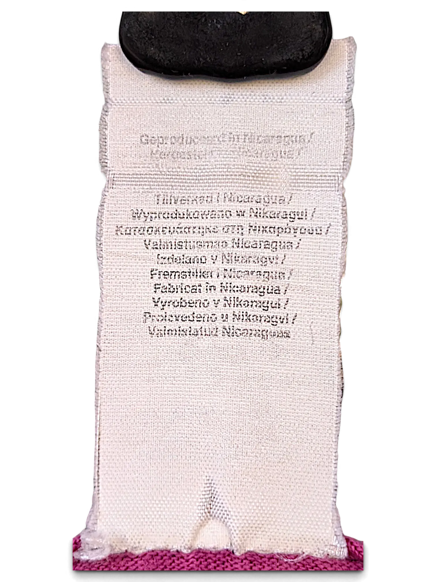 JAKE & IPI white fabric garment care label showing manufacturing origin in Nicaragua in multiple languages