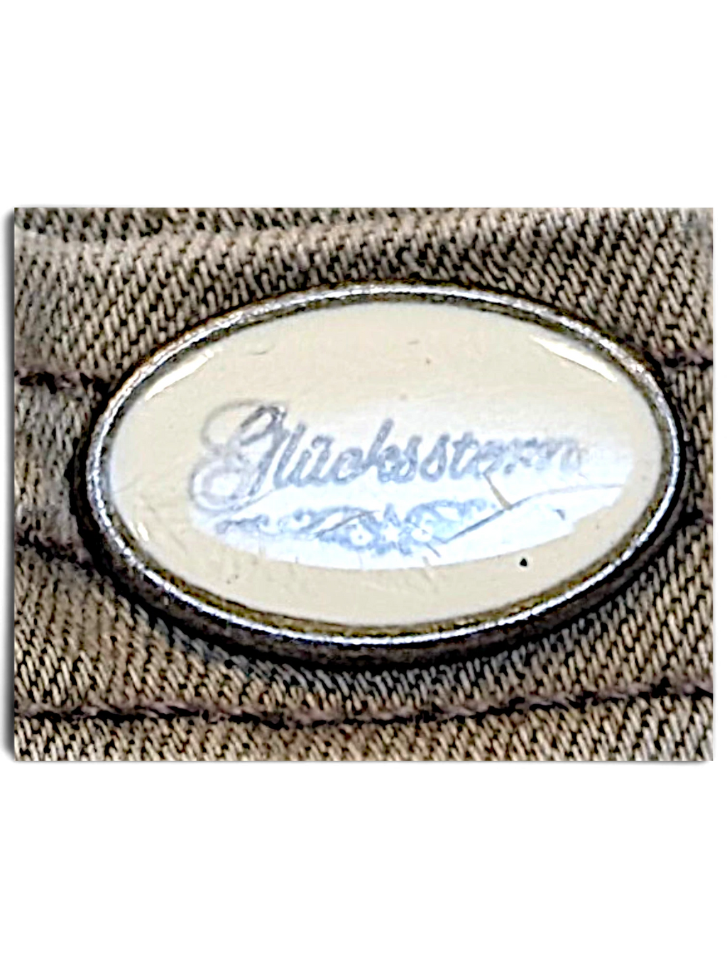 JAKE & IPI Glücksstern light brown casual trousers oval brand logo detail on textured fabric