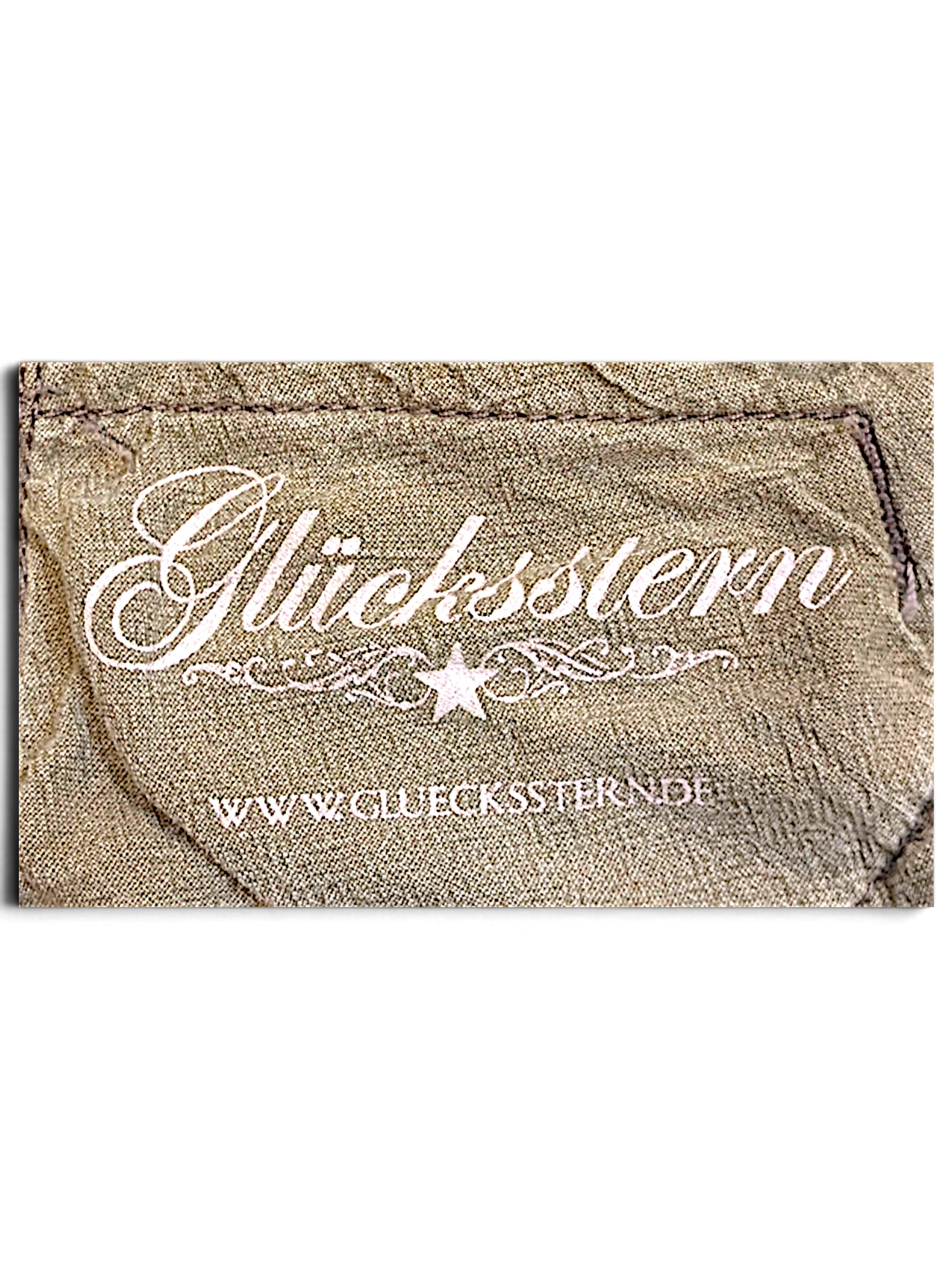 JAKE & IPI Glücksstern brand label on light brown fabric with a distressed, worn-in texture.