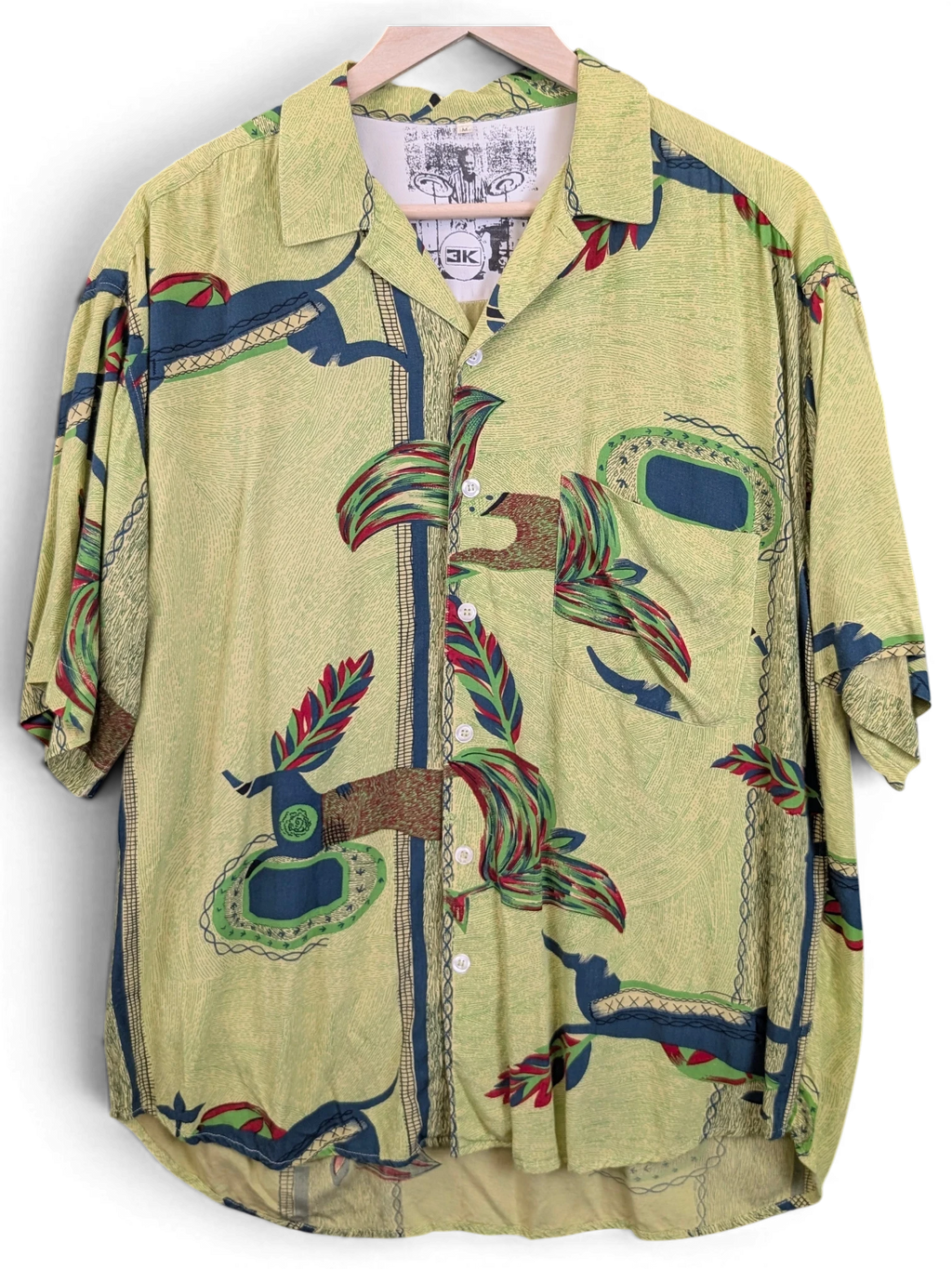 JAKE & IPI green Hawaiian shirt with a textured fabric, button-down front, and abstract tropical leaf patterns.