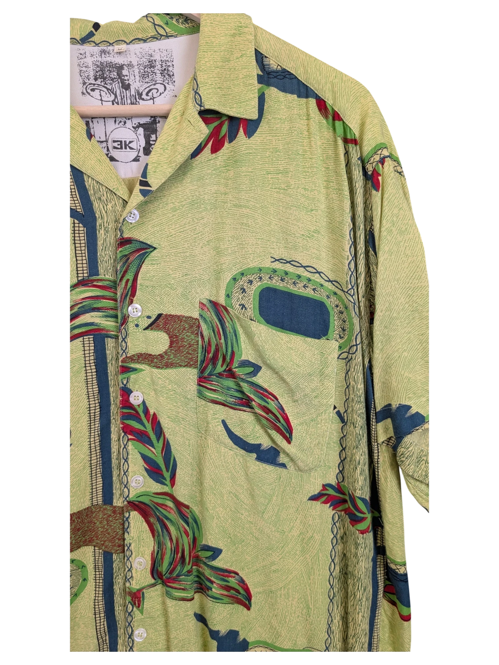 JAKE & IPI green Hawaiian shirt featuring a tropical leaf print, button-down front, and a chest pocket.