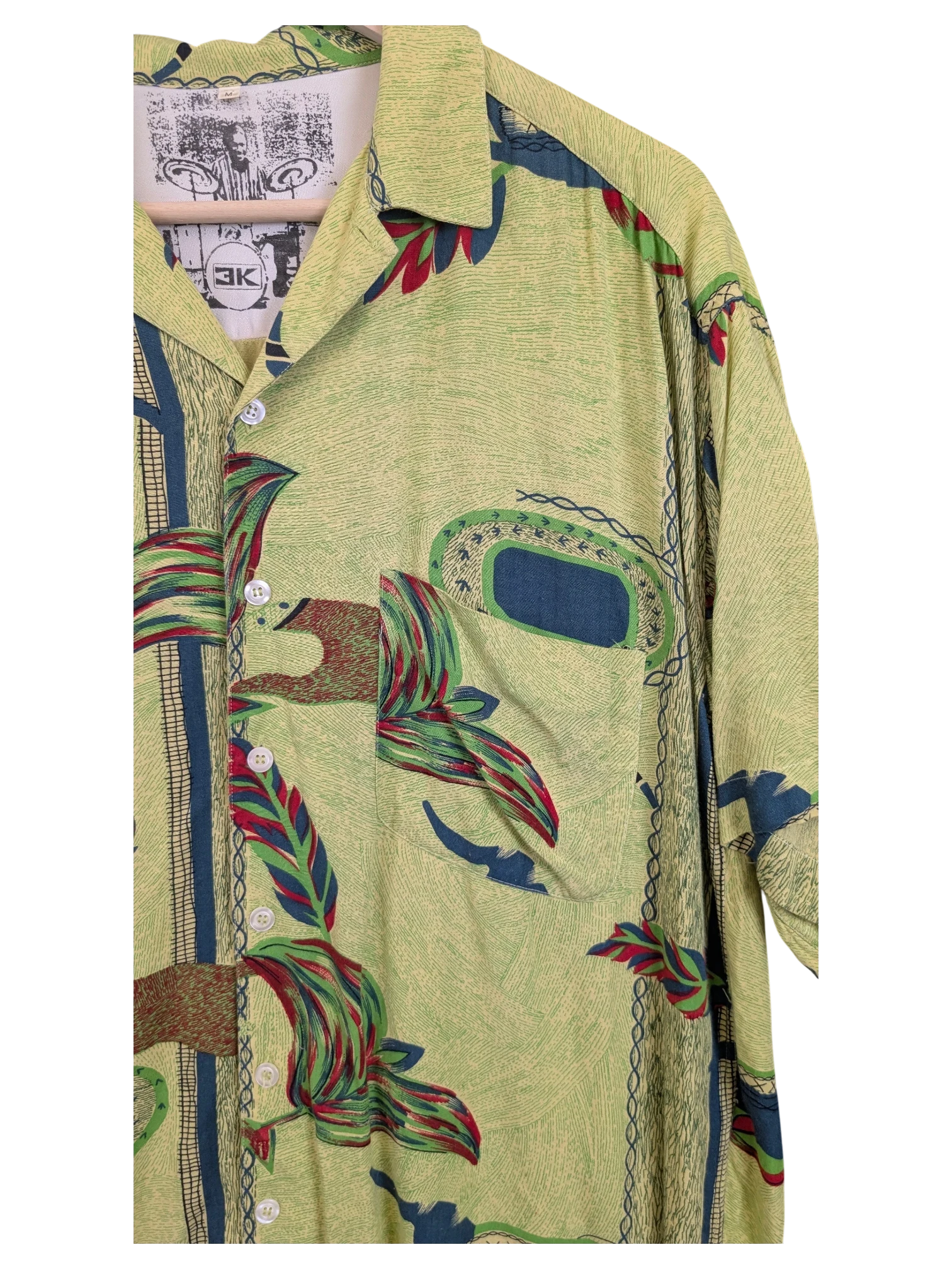 JAKE & IPI green Hawaiian shirt featuring a tropical leaf print, button-down front, and a chest pocket.