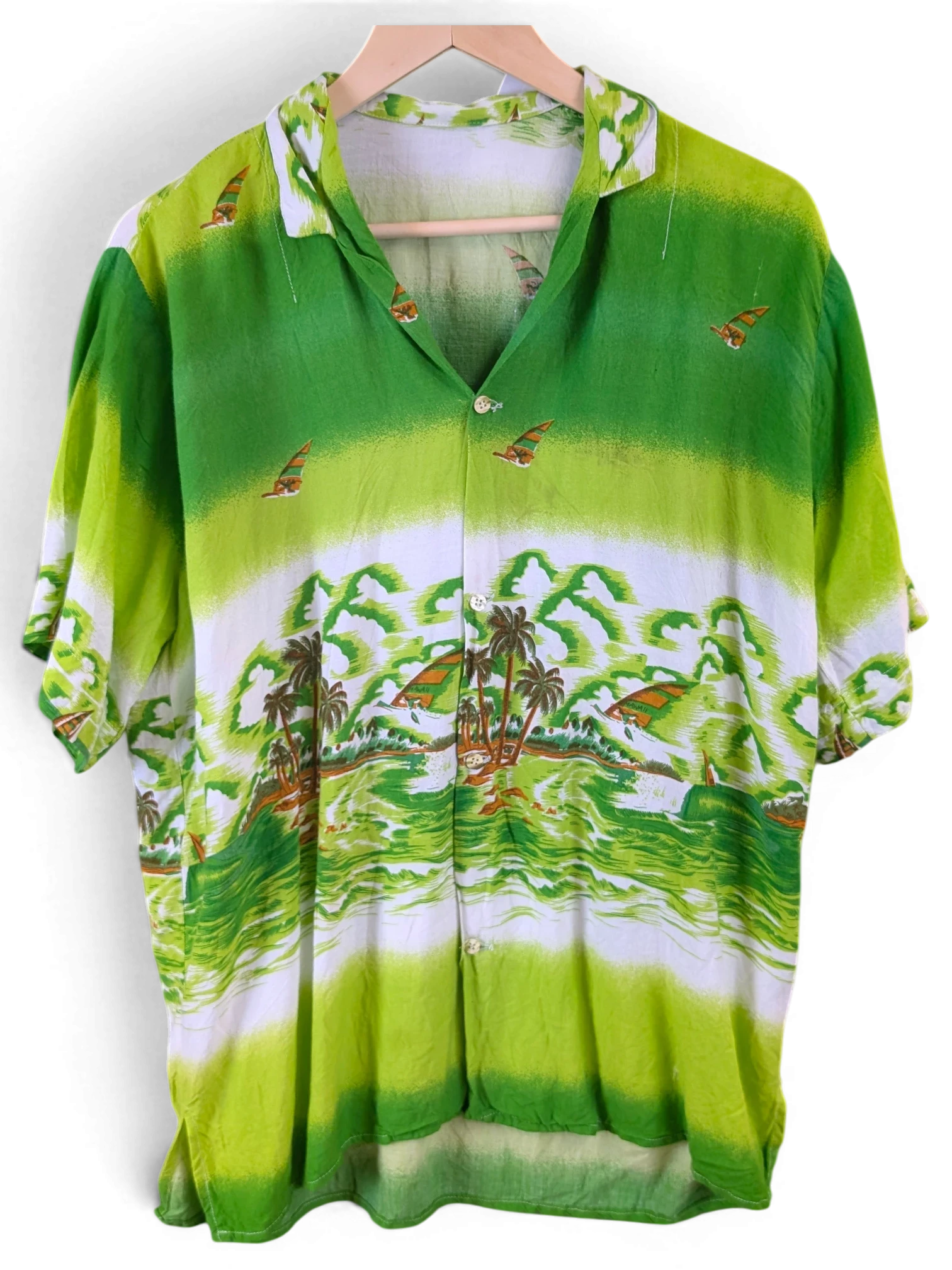 JAKE & IPI green Hawaiian shirt featuring a tropical beach landscape print with palm trees and sailboats