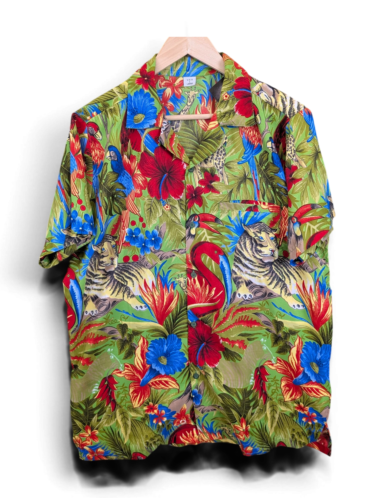JAKE & IPI V.H.O Hawaiian shirt featuring a vibrant green jungle print with tigers, flamingos, and tropical flowers.