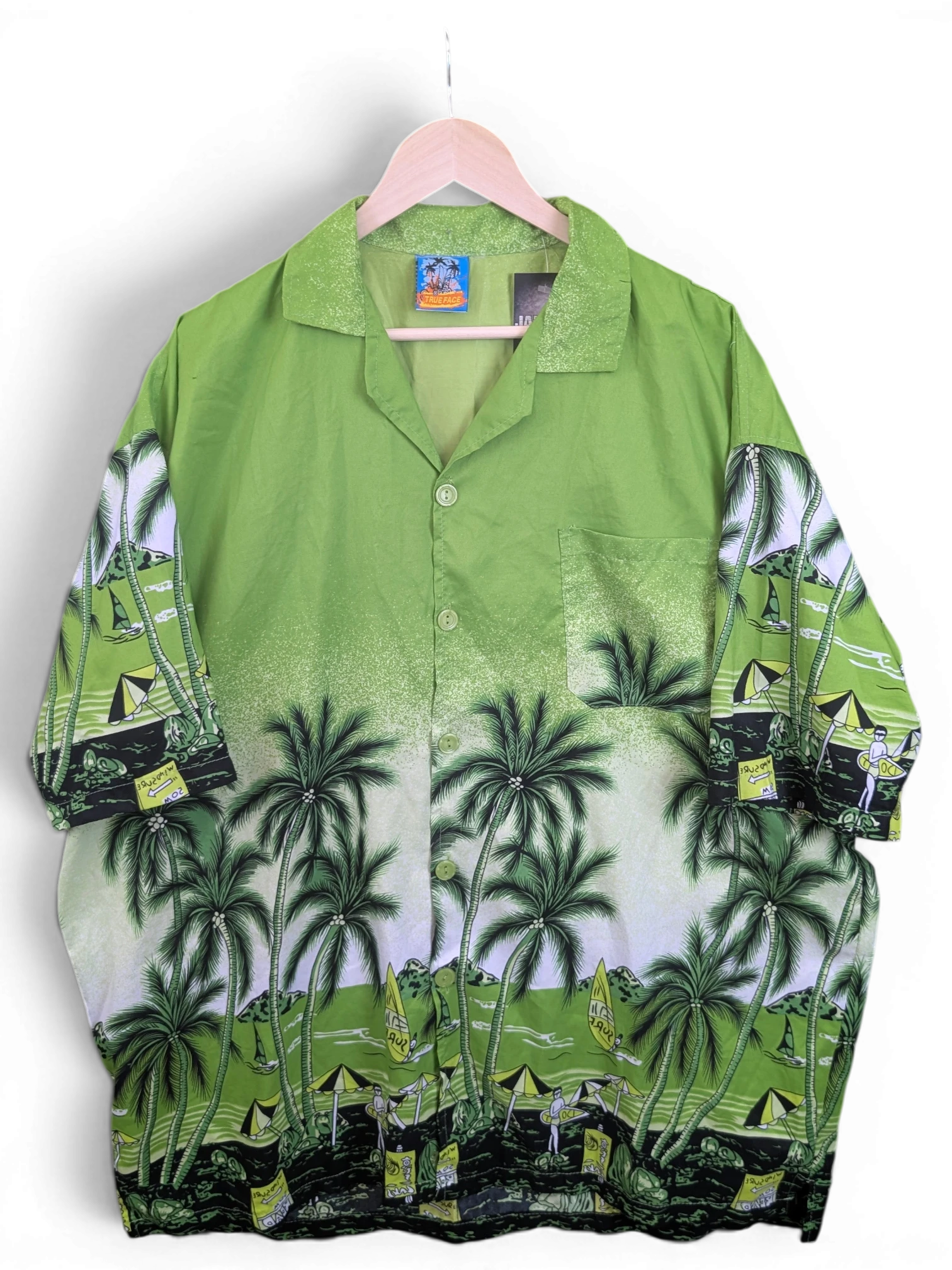 JAKE & IPI green Hawaiian shirt featuring a tropical palm tree and beach scene print with a button-down front.