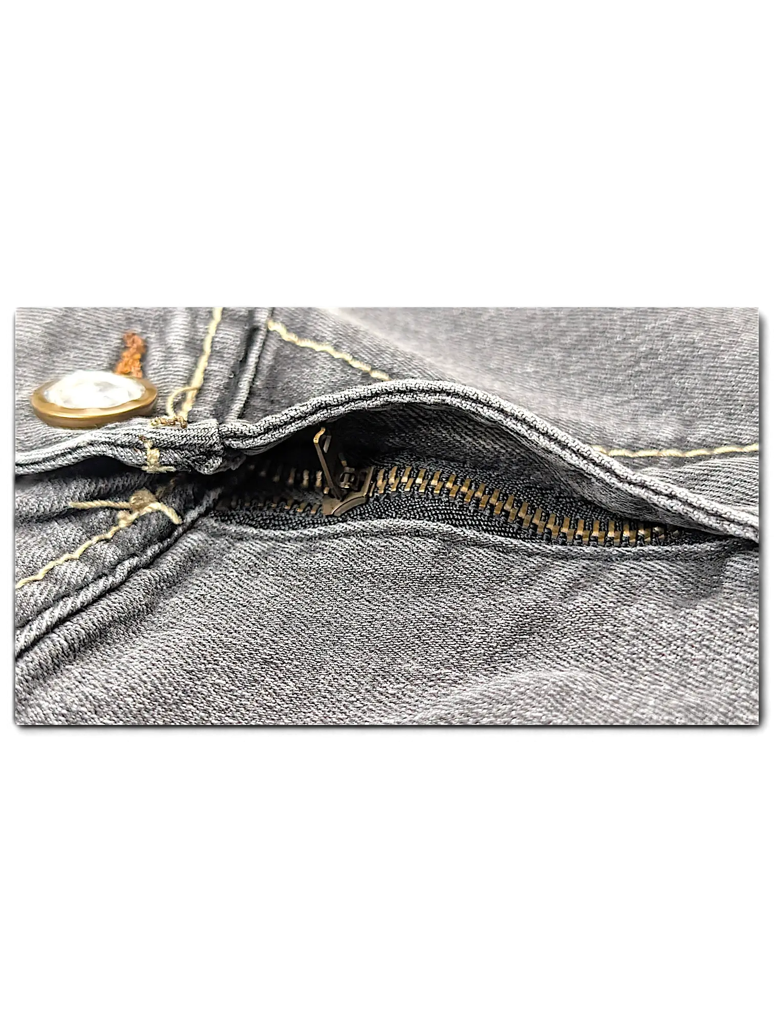 Close-up of JAKE & IPI SP Classic Y2K Jeans 20 featuring grey denim fabric, a metal zipper, and contrast stitching.