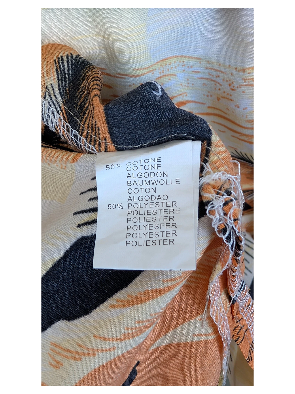 JAKE & IPI New Base Hawaiian shirt fabric care label showing a 50% cotton and 50% polyester blend composition
