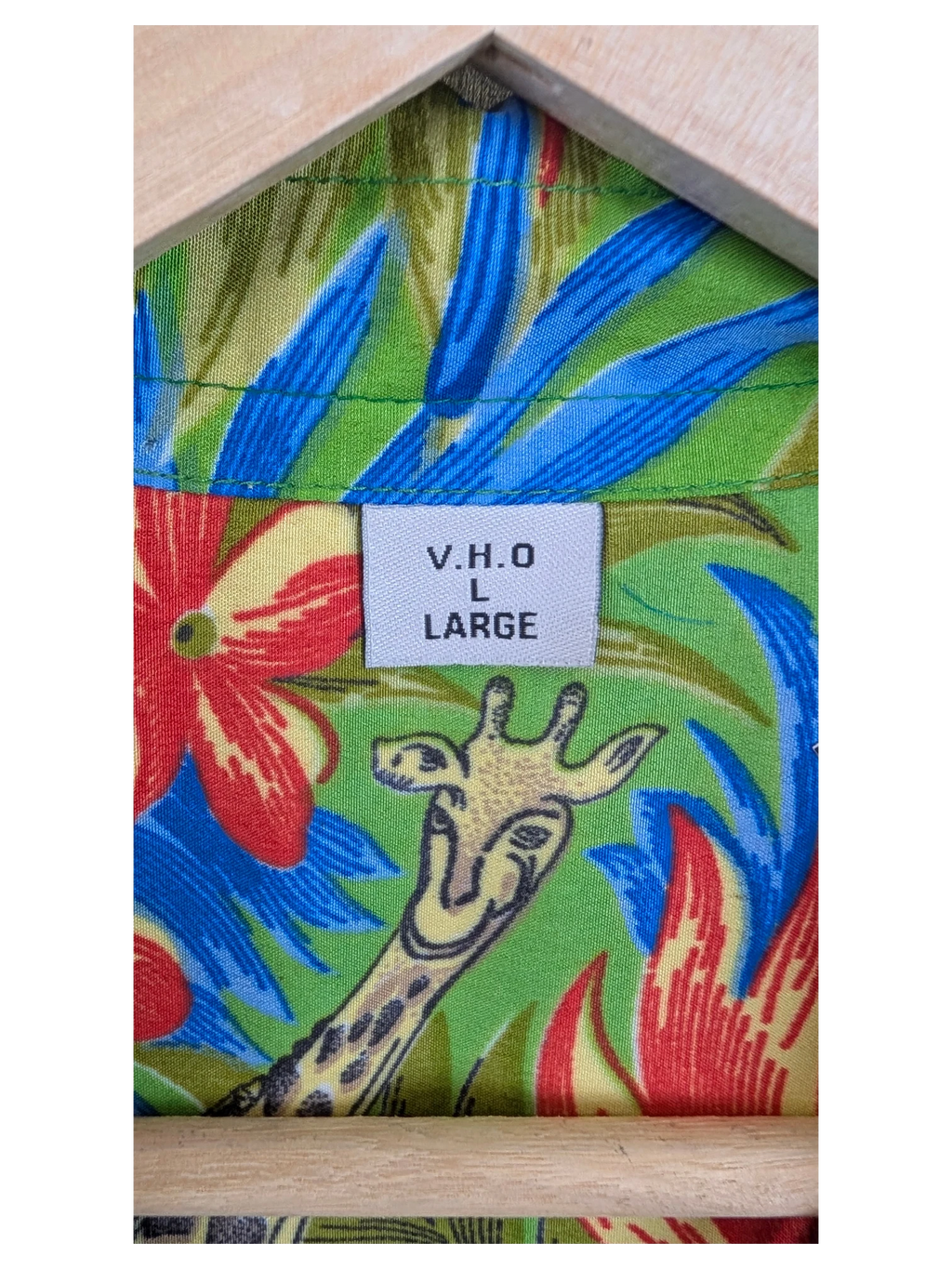 JAKE & IPI V.H.O Hawaiian shirt featuring a vibrant green fabric with a giraffe and tropical floral print