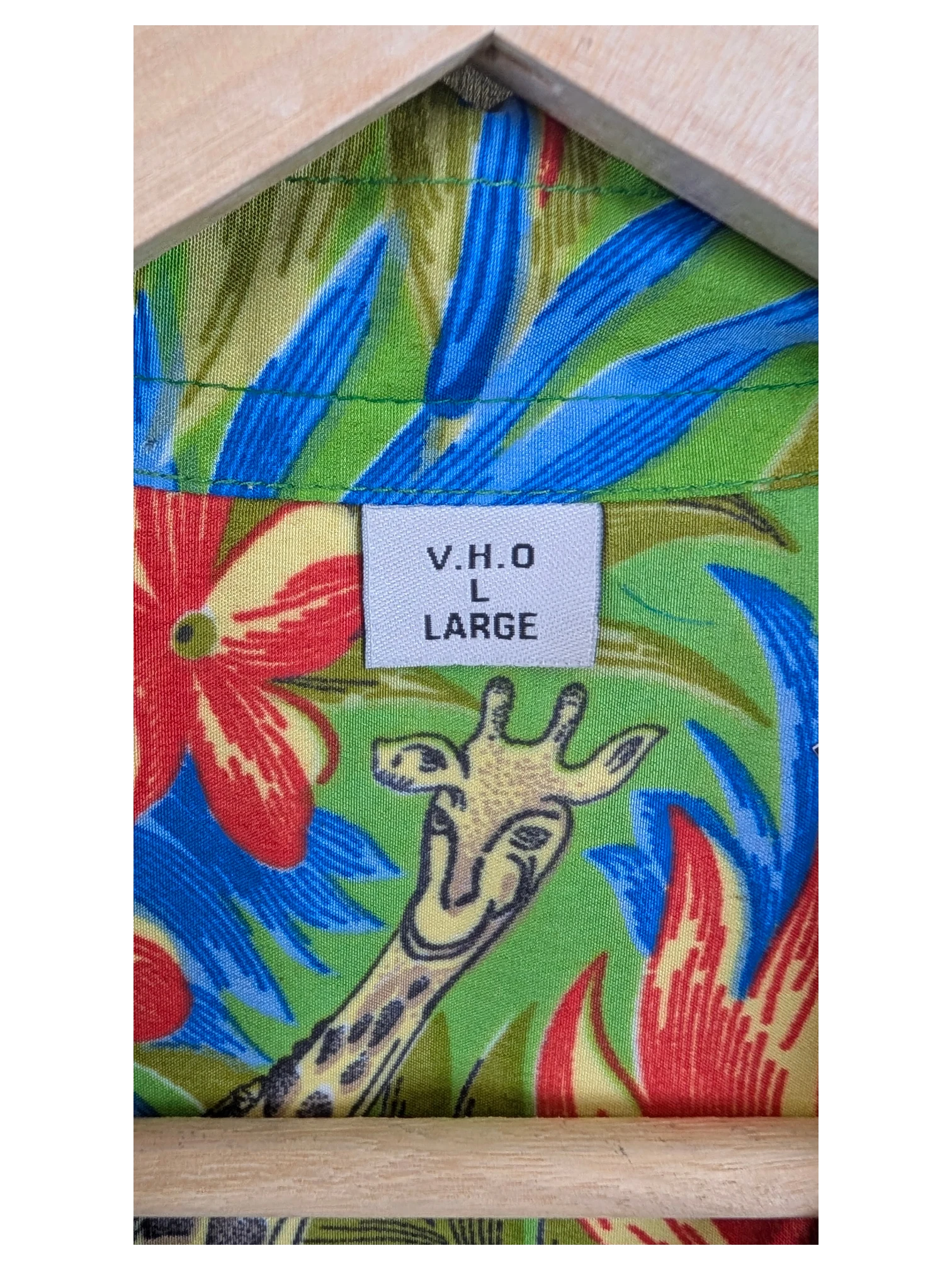 JAKE & IPI V.H.O Hawaiian shirt featuring a vibrant green fabric with a giraffe and tropical floral print