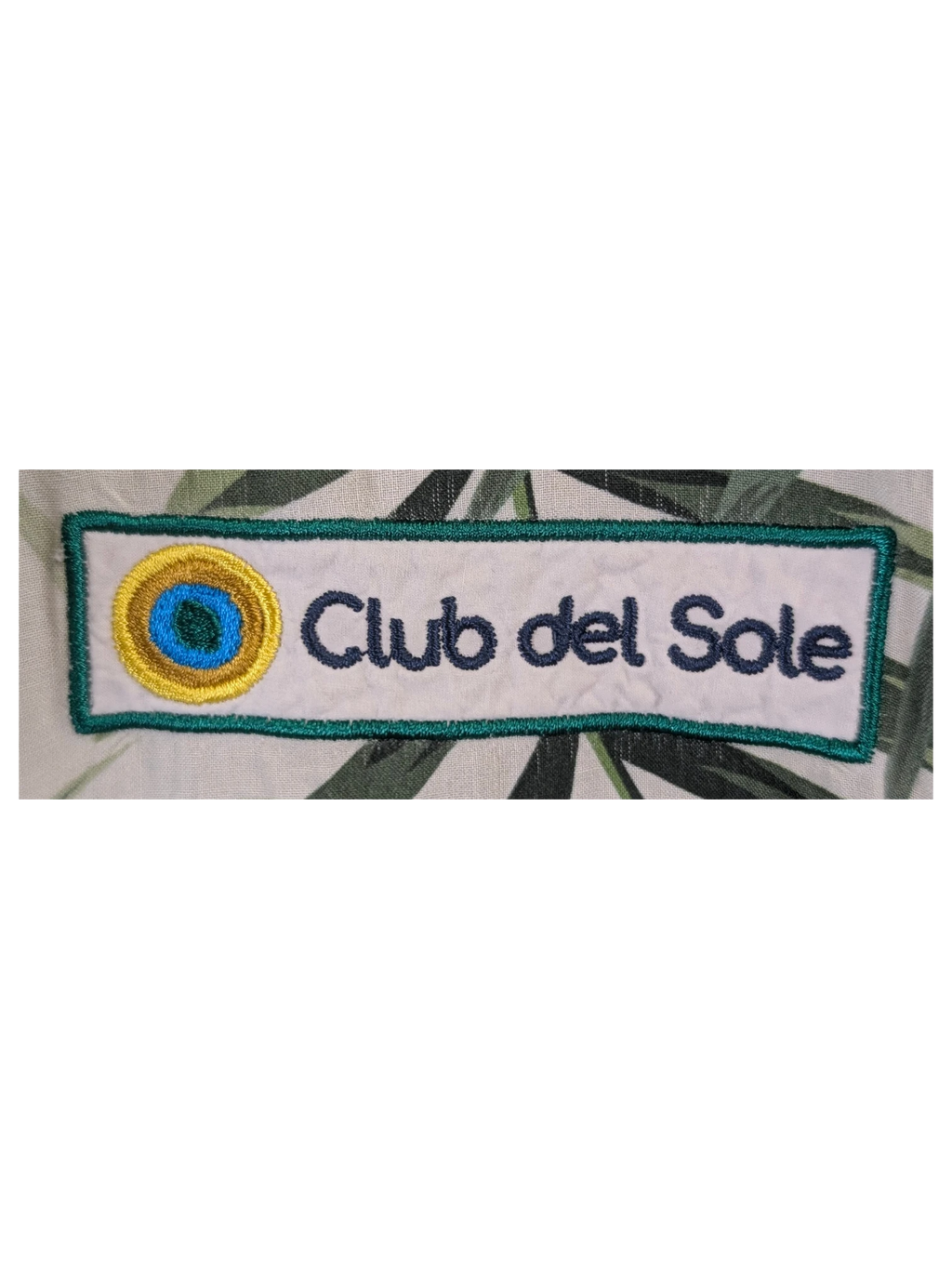 JAKE & IPI Gary's Hawaiian shirt in white and green palm leaf print with a Club del Sole patch, missing a button.
