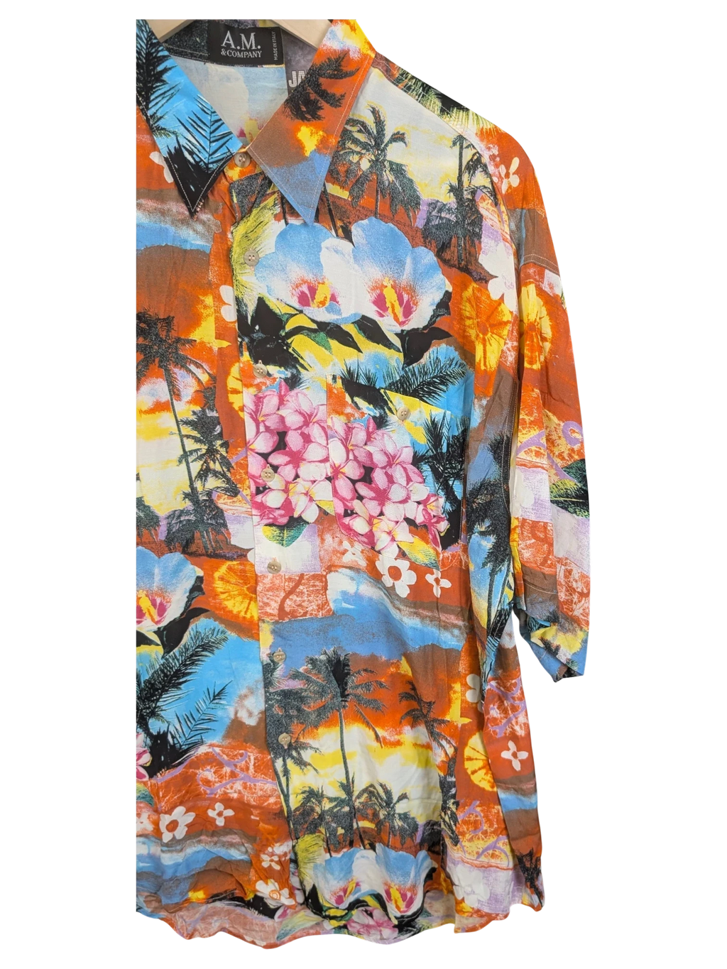 JAKE & IPI A.M. & Company Hawaiian shirt featuring a vibrant tropical print with palm trees and hibiscus flowers.