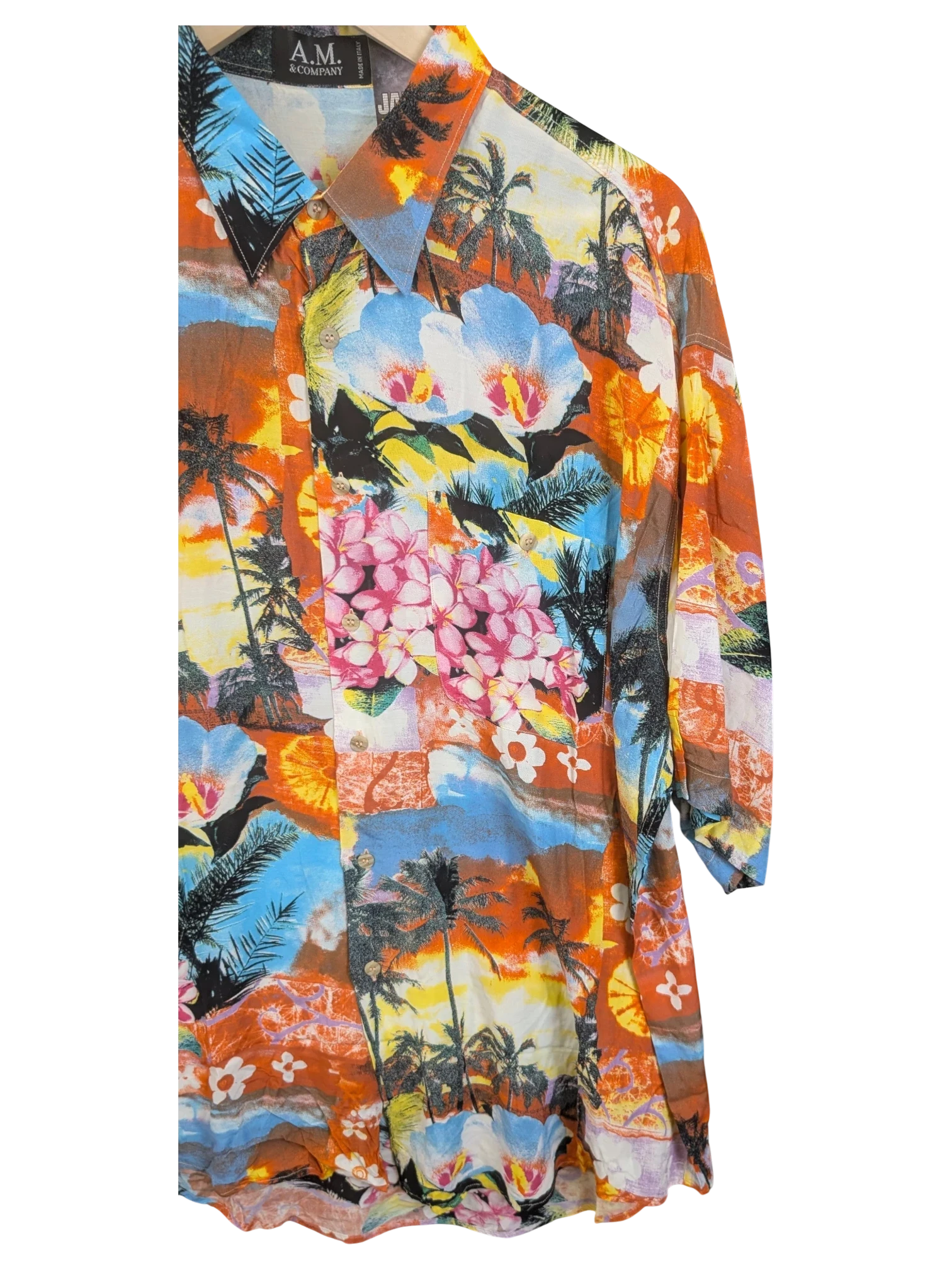 JAKE & IPI A.M. & Company Hawaiian shirt featuring a vibrant tropical print with palm trees and hibiscus flowers.