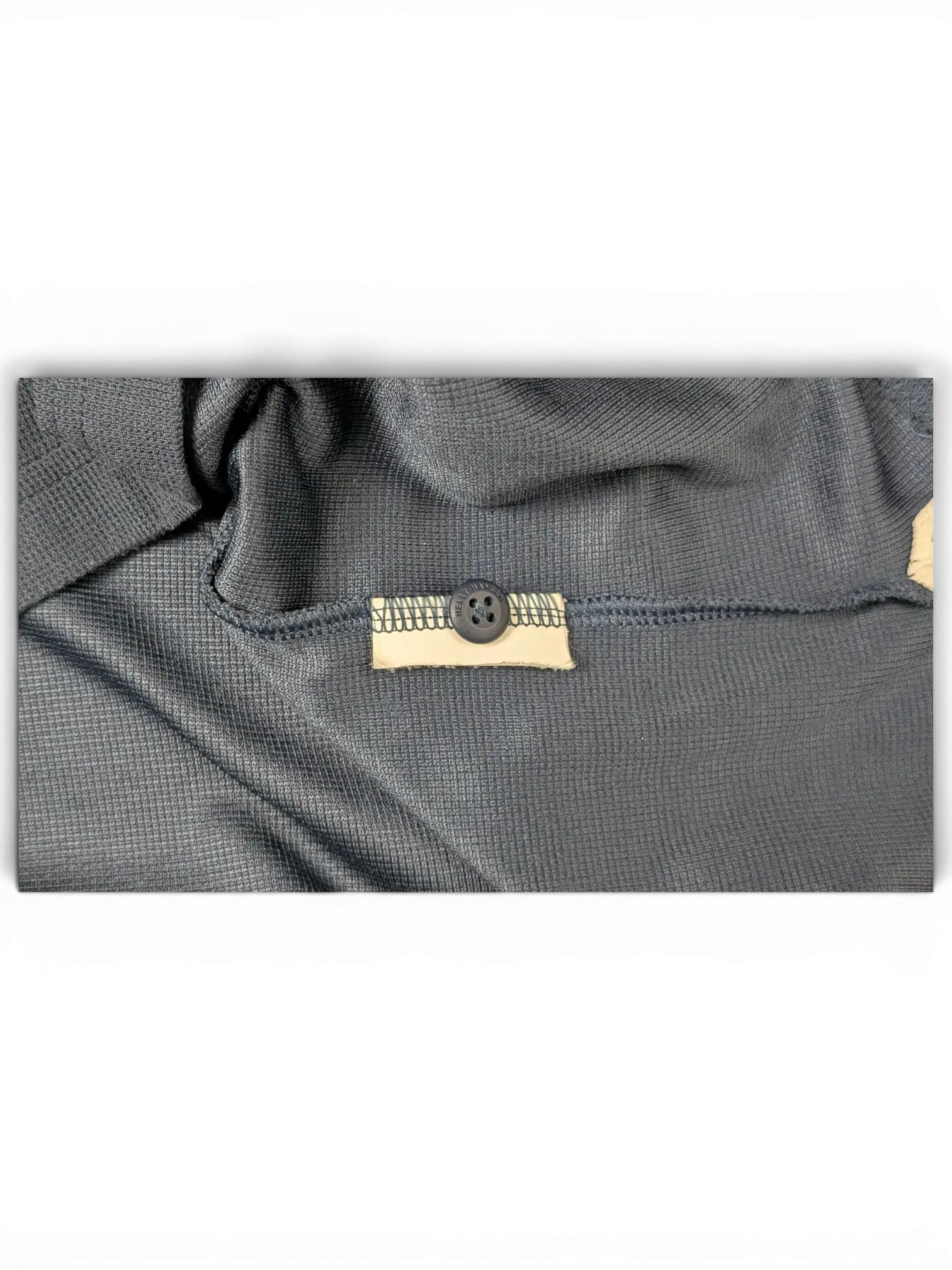 JAKE & IPI pre-owned Helly Hansen navy polo shirt featuring a textured fabric and branded button detail