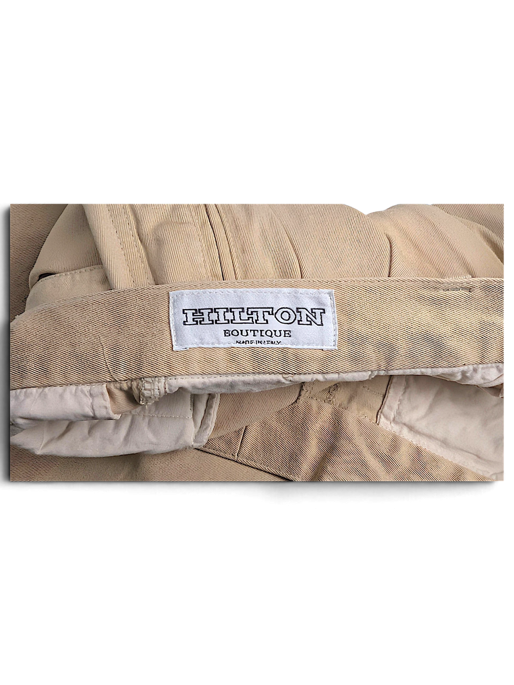 JAKE & IPI Hilton Boutique beige pleated trousers featuring a tailored waistband and interior brand label