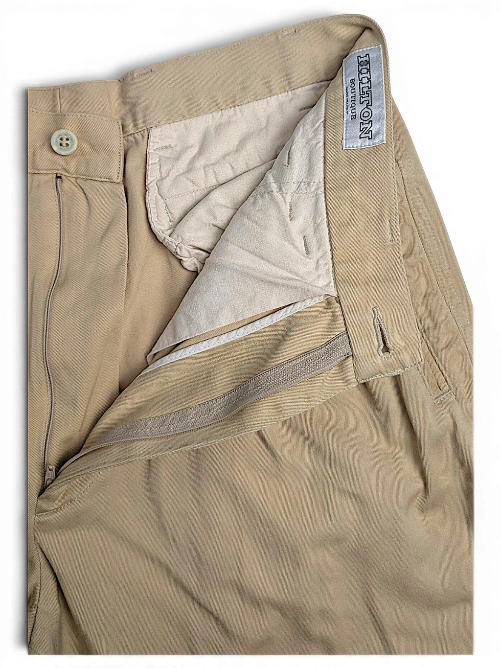 JAKE & IPI Hilton Boutique beige pleated trousers with a tailored waistband and zip fly closure.