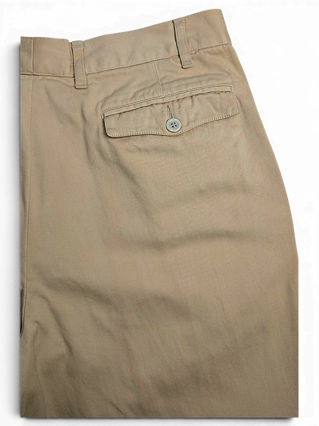 JAKE & IPI Hilton Boutique beige pleated trousers featuring a tailored waistband and a buttoned back pocket.