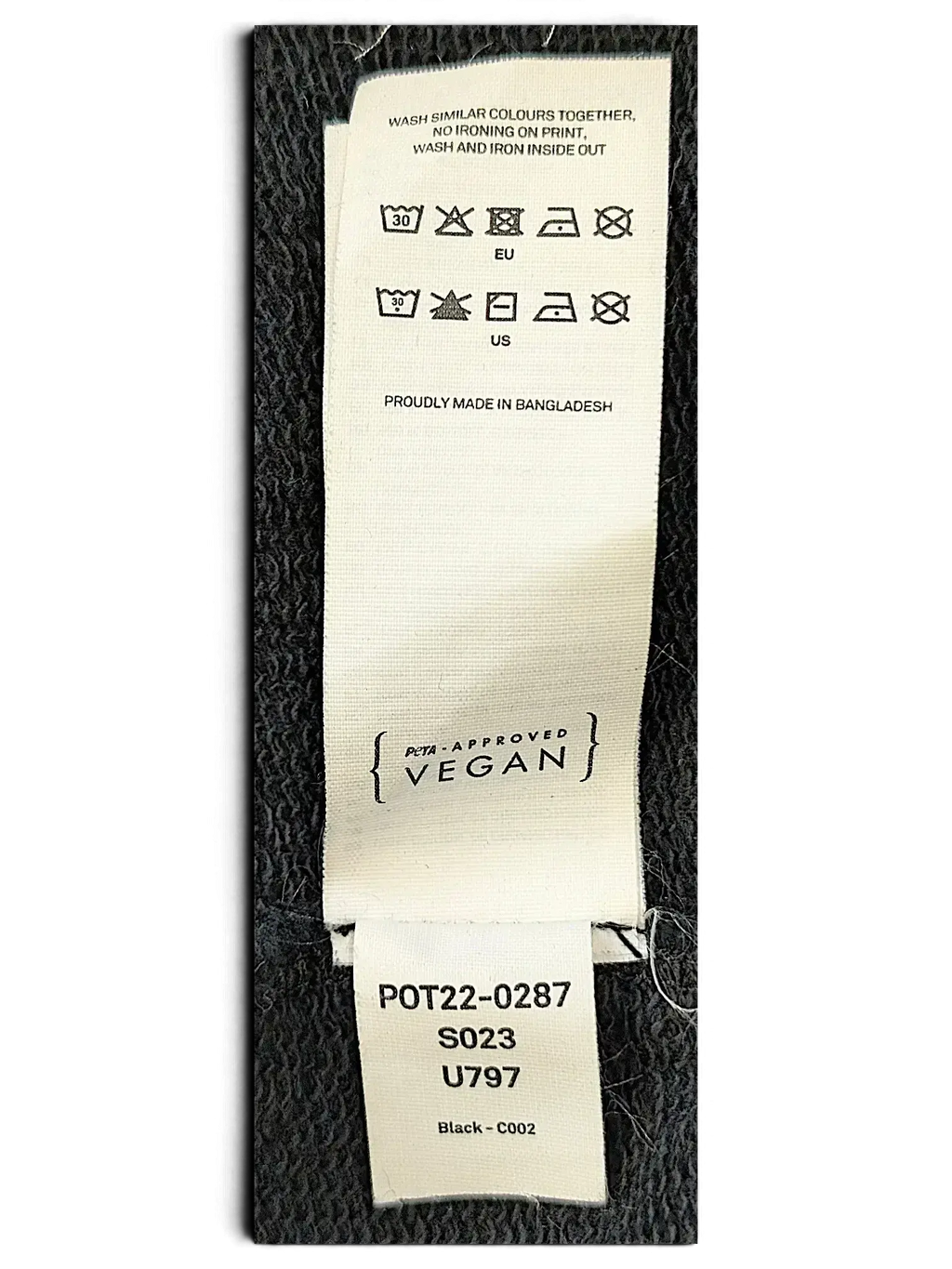 JAKE & IPI IBE Pyzze Hoodie white fabric care label with washing instructions and PETA-Approved Vegan certification