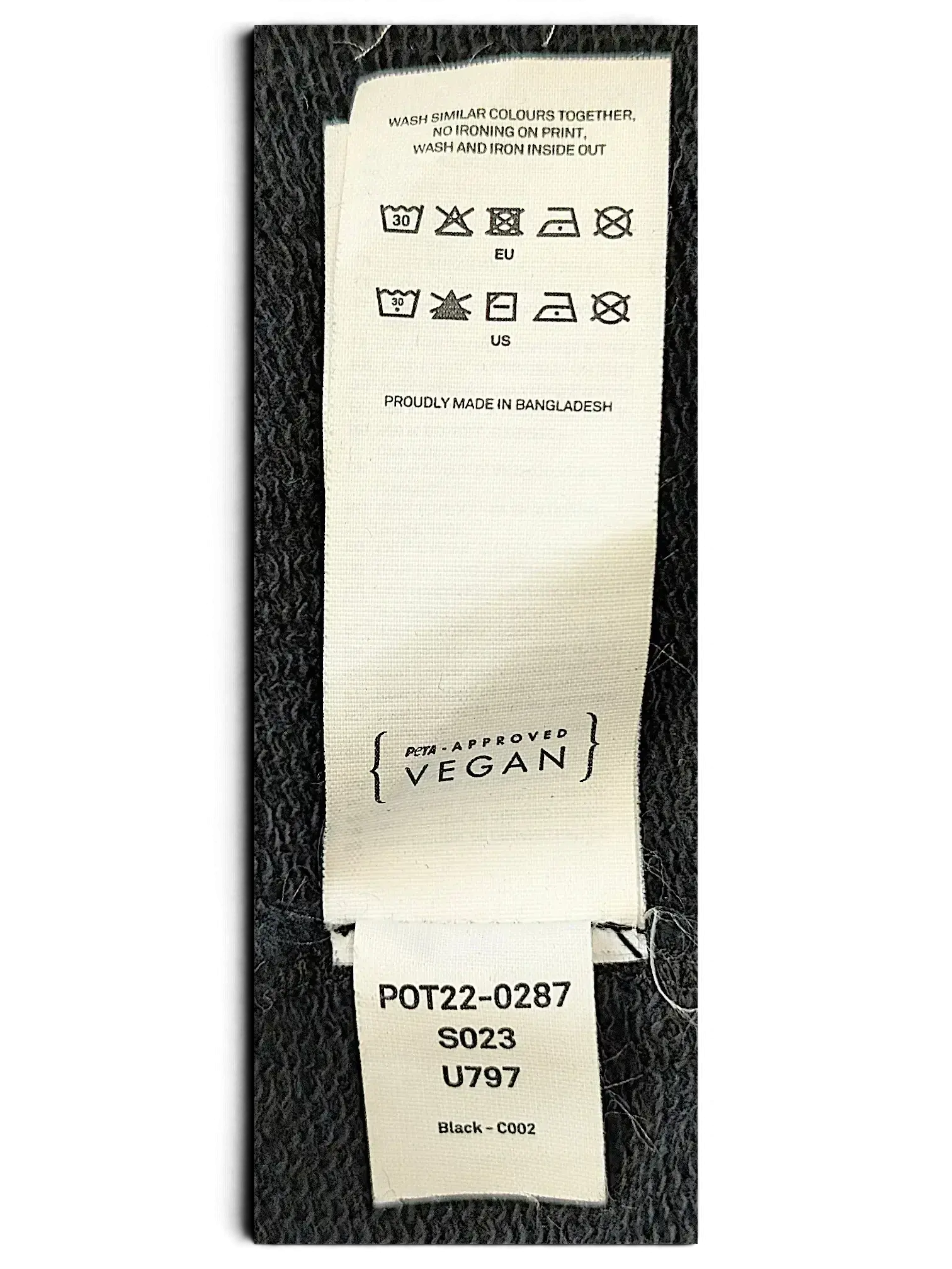 JAKE & IPI IBE Pyzze Hoodie white fabric care label with washing instructions and PETA-Approved Vegan certification