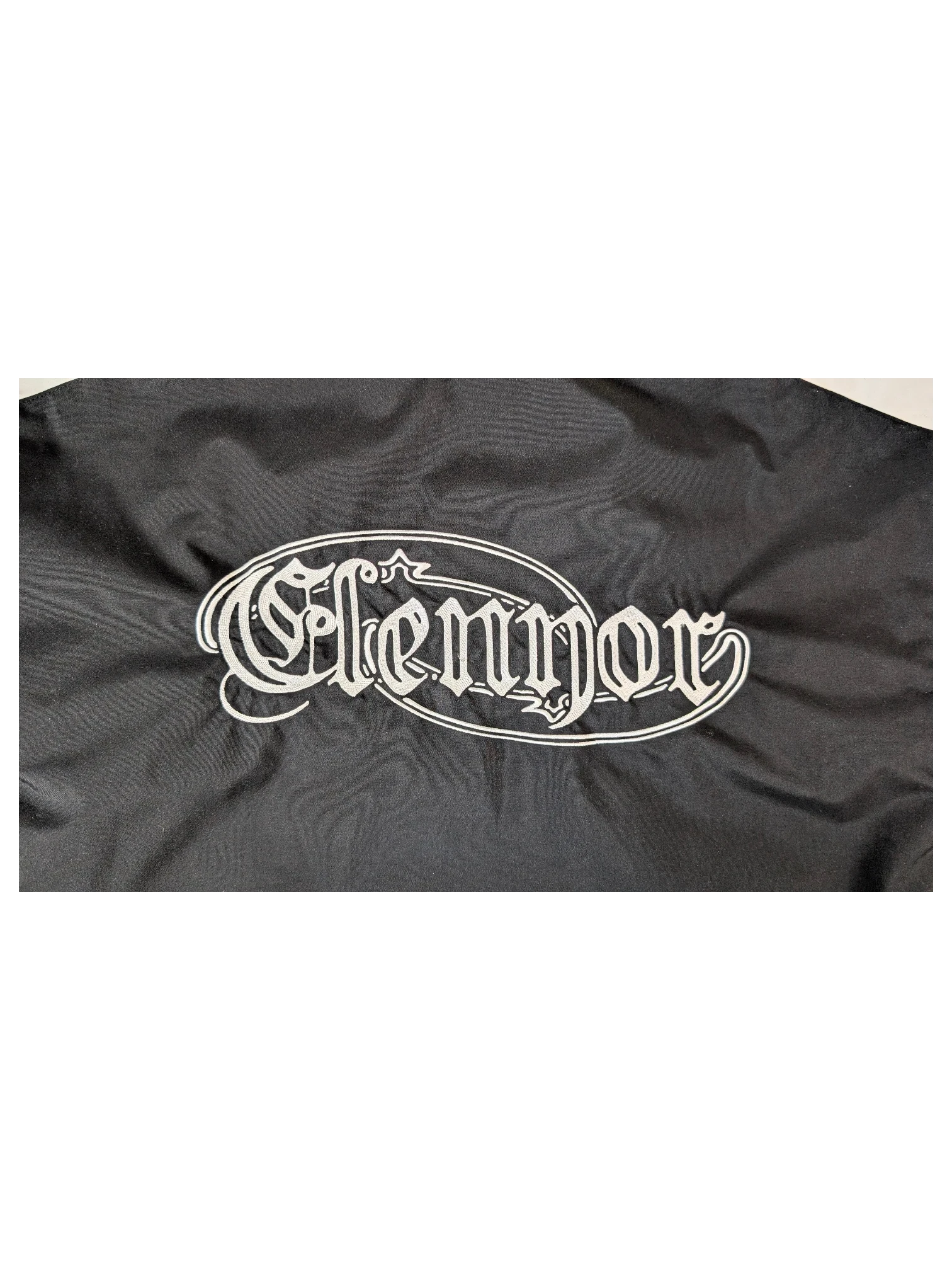 JAKE & IPI black IBE Elenyor jacket featuring white gothic-style embroidered logo lettering on the back