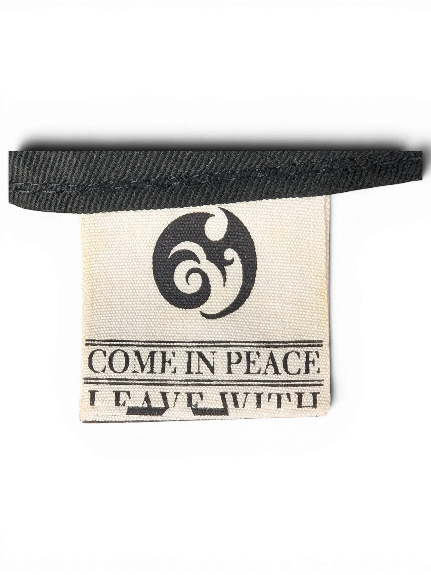 JAKE & IPI IBE Morivelle cap interior fabric label with Come In Peace branding and logo