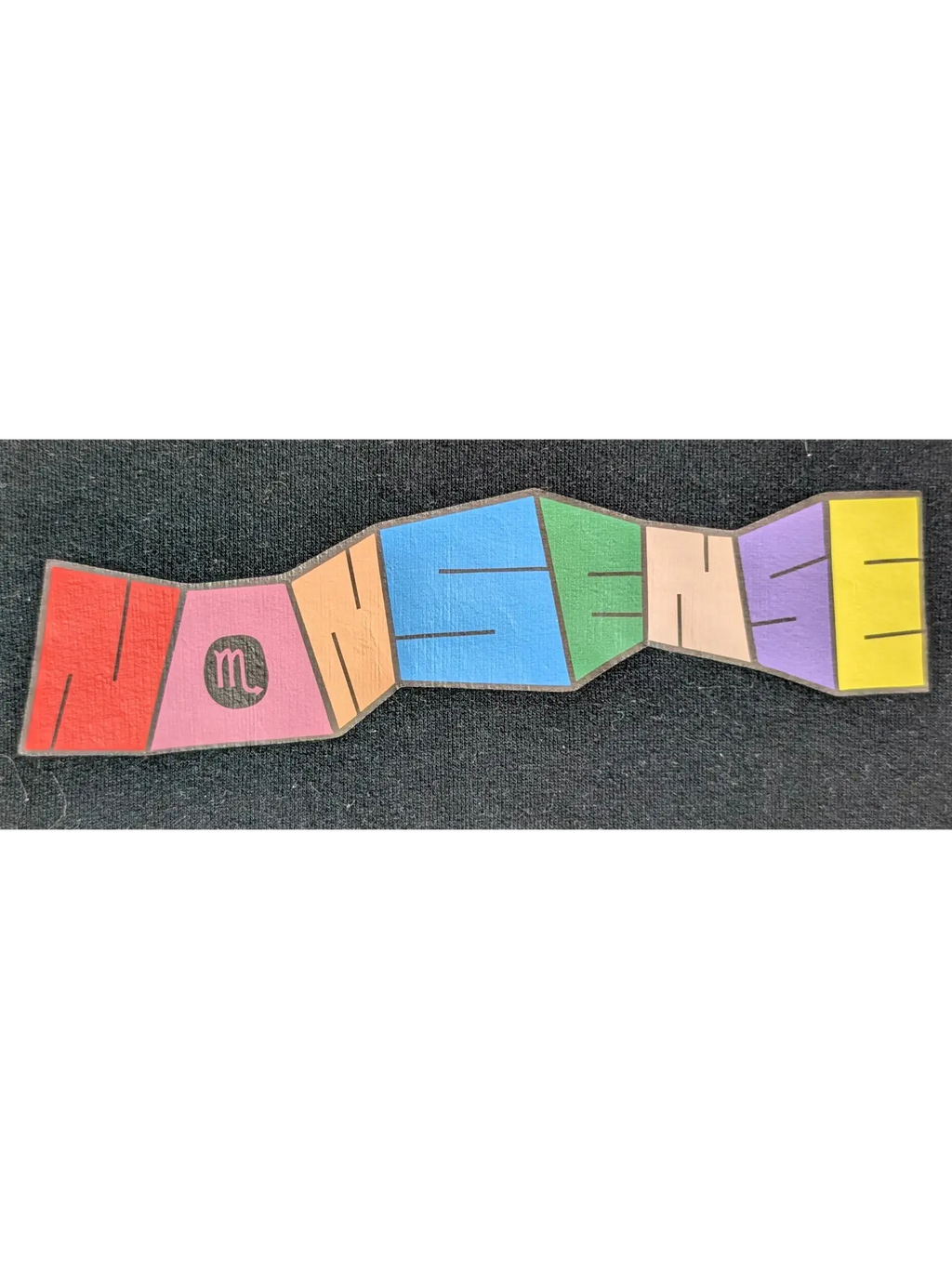 JAKE & IPI IBE Personal Nonsense graphic print on a black cotton garment featuring colorful segmented lettering