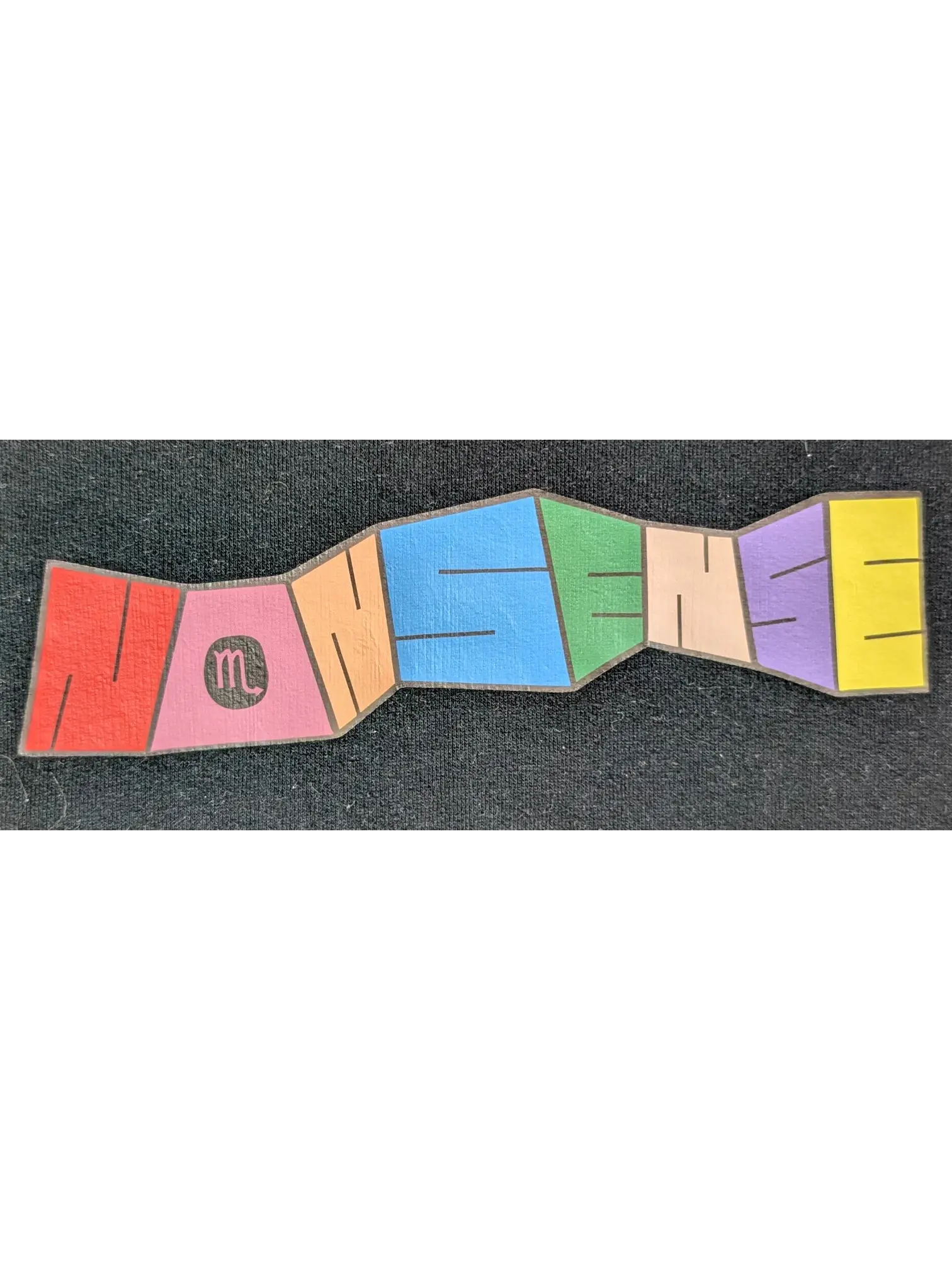 JAKE & IPI IBE Personal Nonsense graphic print on a black cotton garment featuring colorful segmented lettering