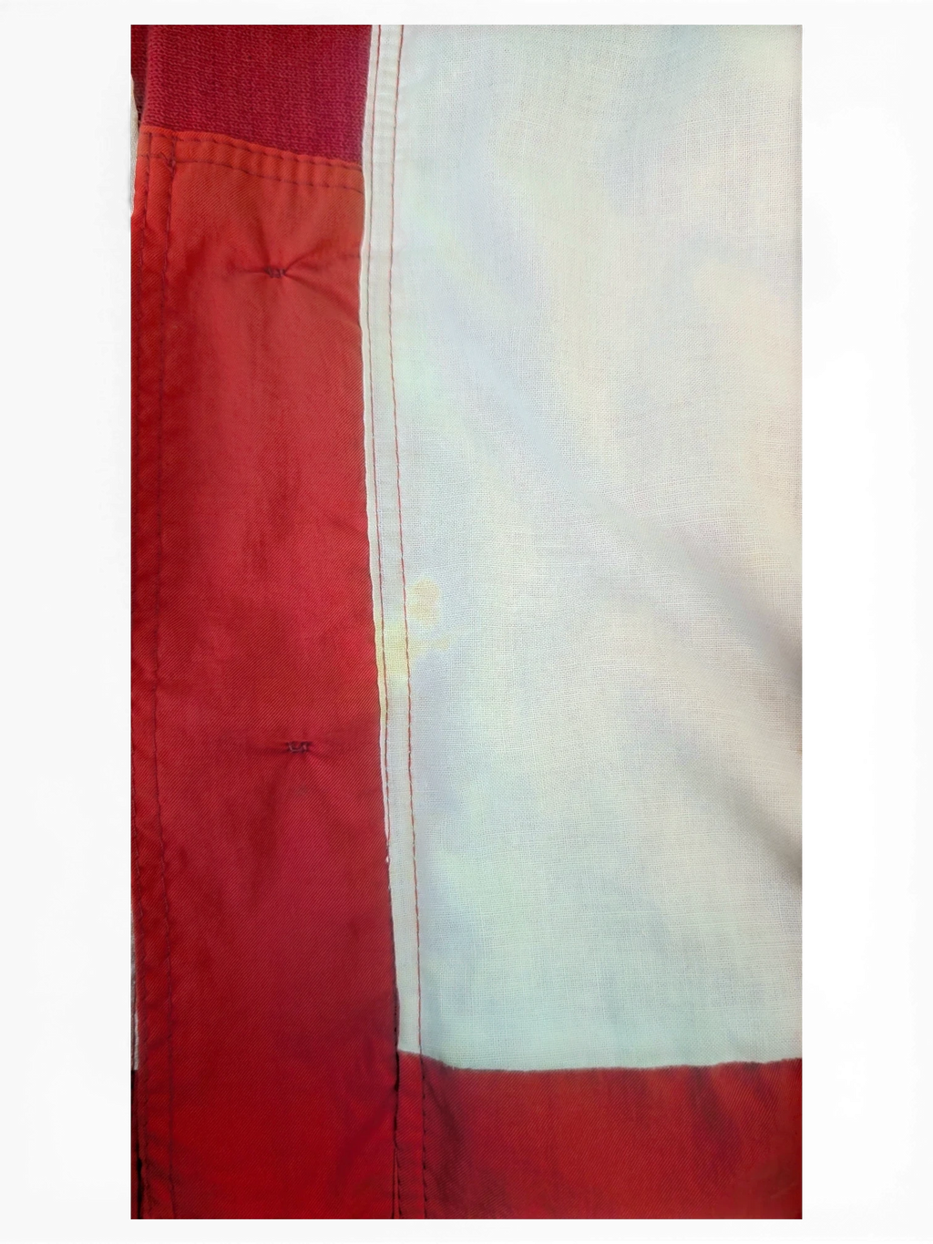 JAKE & IPI IBE Toyota club jacket detail showing red fabric trim and white lining with a small stain