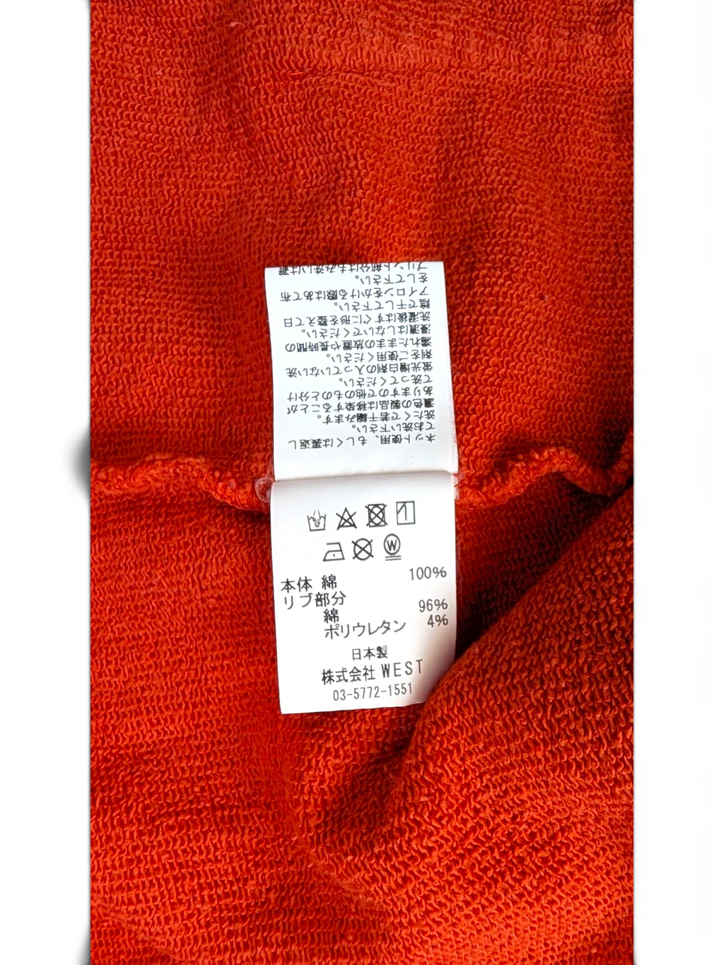JAKE & IPI Icecream zip hoodie interior care label showing fabric composition and washing instructions on orange fabric