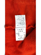 JAKE & IPI Icecream zip hoodie interior care label showing fabric composition and washing instructions on orange fabric