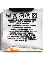 JAKE & IPI Indian Rose white cargo pants care label with washing instructions and orange contrast stitching detail