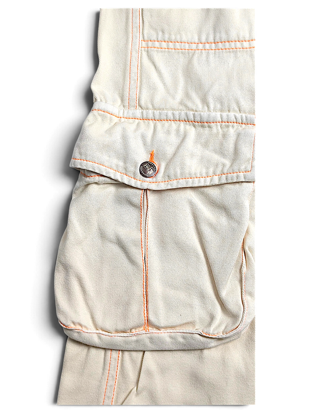 JAKE & IPI Indian Rose white cotton cargo pants featuring orange contrast stitching and a utility pocket detail.