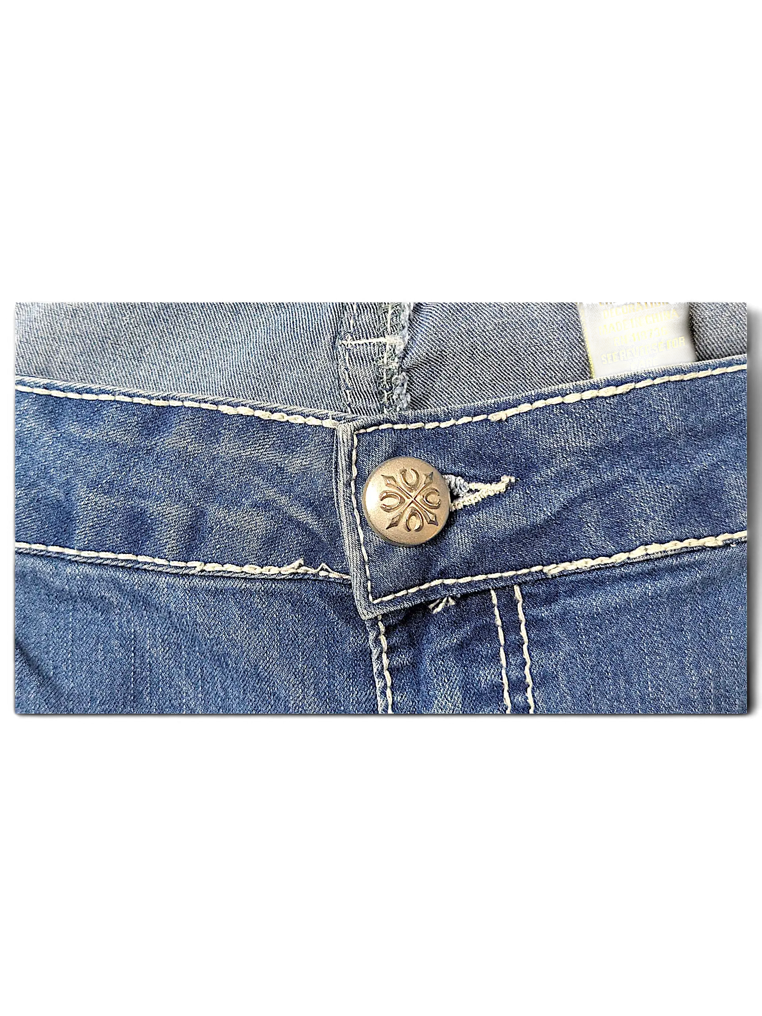 JAKE & IPI Love X Indigo Y2K jeans featuring a silver embossed button and thick white contrast stitching