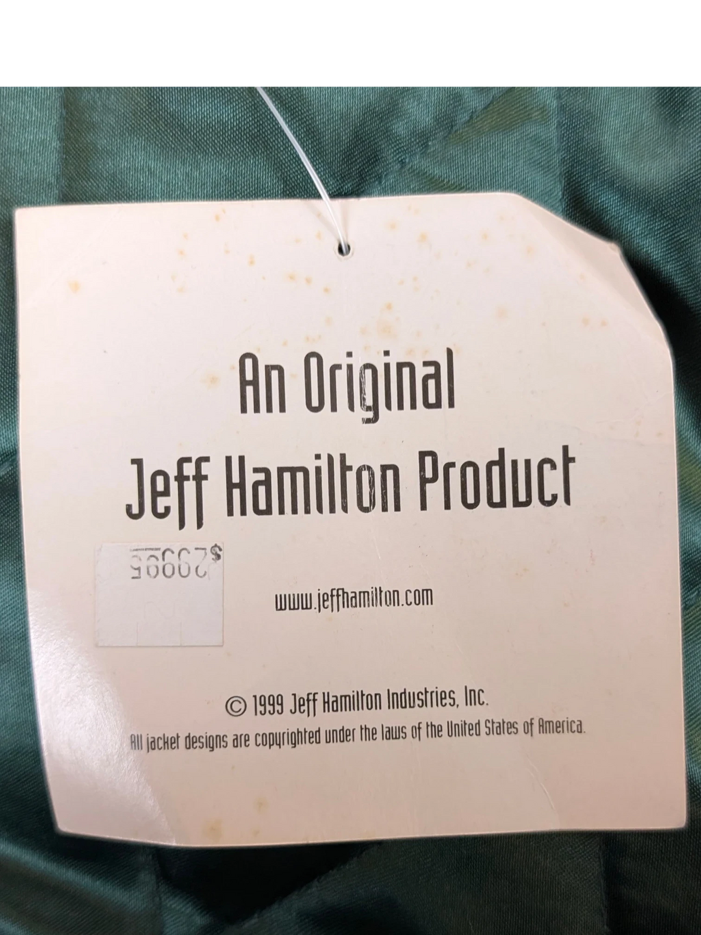 JAKE & IPI original Jeff Hamilton varsity jacket product tag with 1999 copyright information