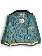 JAKE & IPI Jeff Hamilton varsity jacket interior with green quilted lining, branded labels, and striped hem.