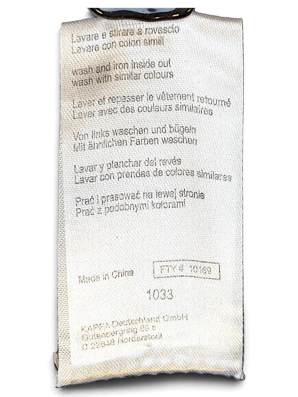 JAKE & IPI Kappa track pants care label with washing instructions and manufacturing details in multiple languages.