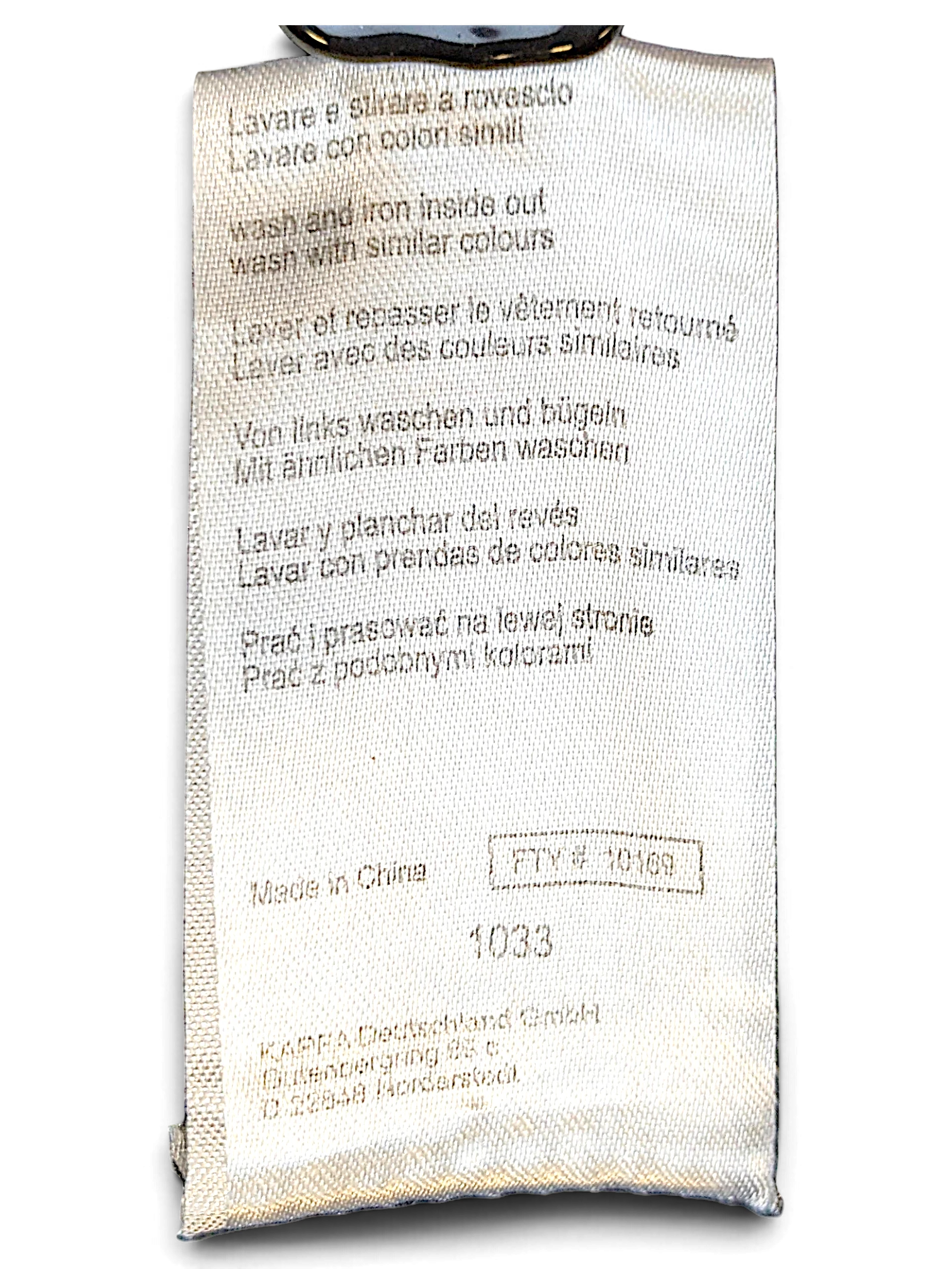 JAKE & IPI Kappa track pants care label with washing instructions and manufacturing details in multiple languages.
