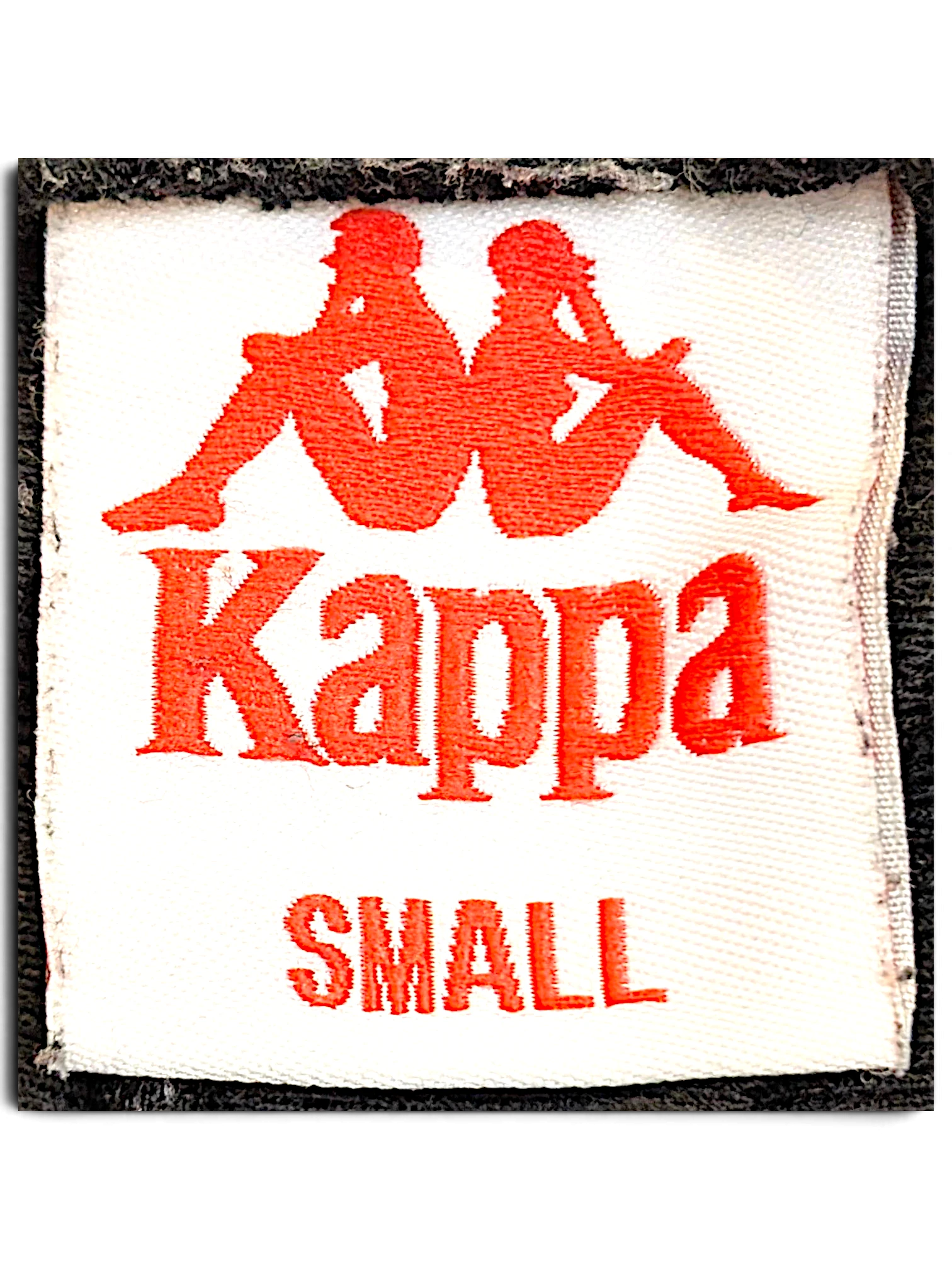 JAKE & IPI Kappa track pants size small clothing label with red embroidered logo on white fabric